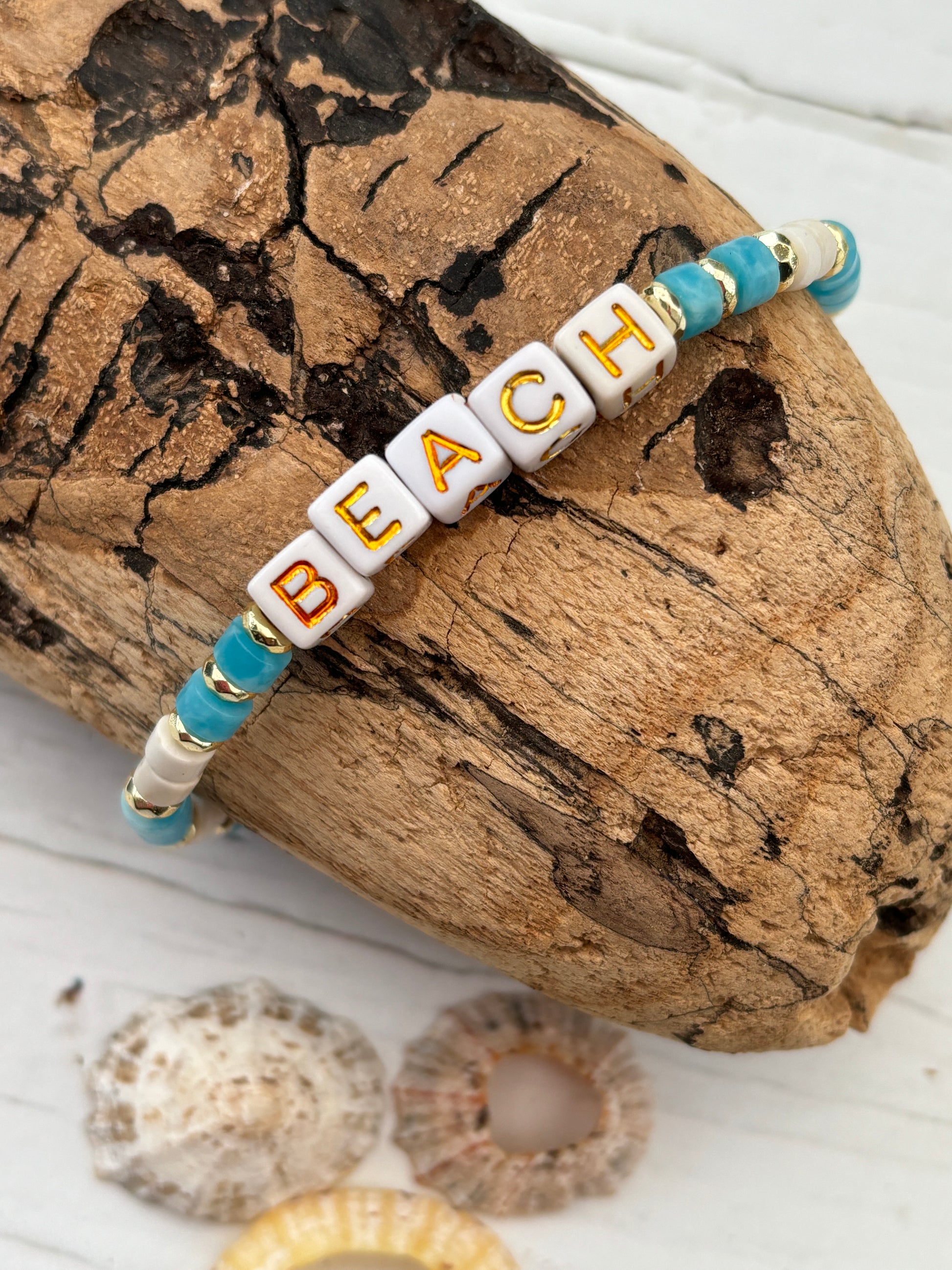 "BEACH" bracelet—white cube beads with gold letters, blue, white, and gold accents, handmade coastal boho jewelry