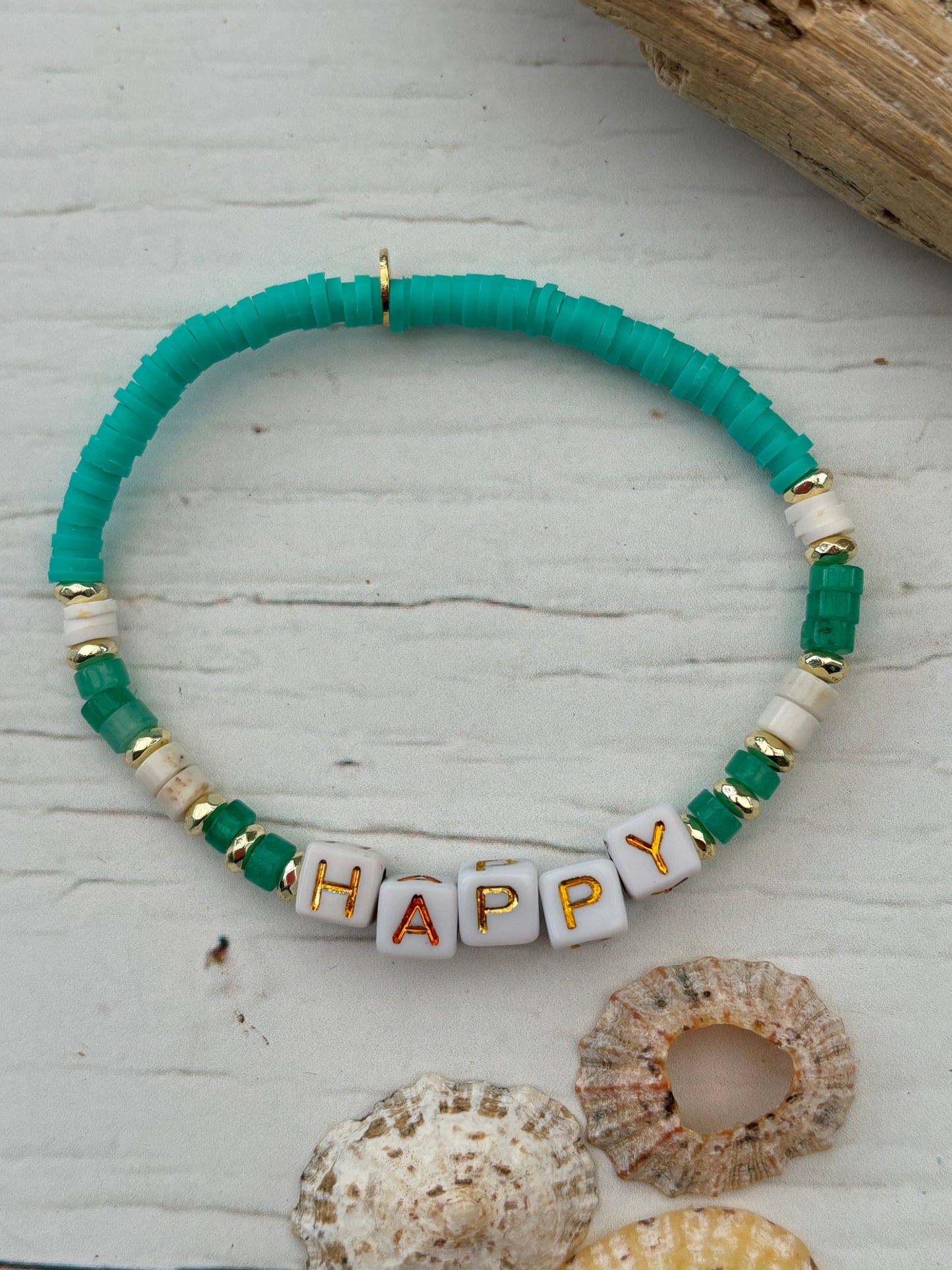 handmade beach bracelet—turquoise, gold, and white beads with “HAPPY” cubes, coastal boho gift with positive vibes