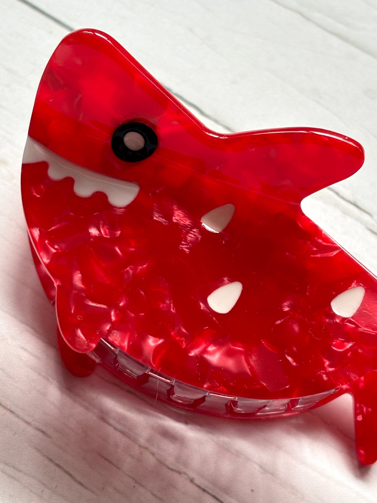 red shark hair claw with marbled texture, toothy grin, and bold eye—fun, secure clip for quirky everyday styling