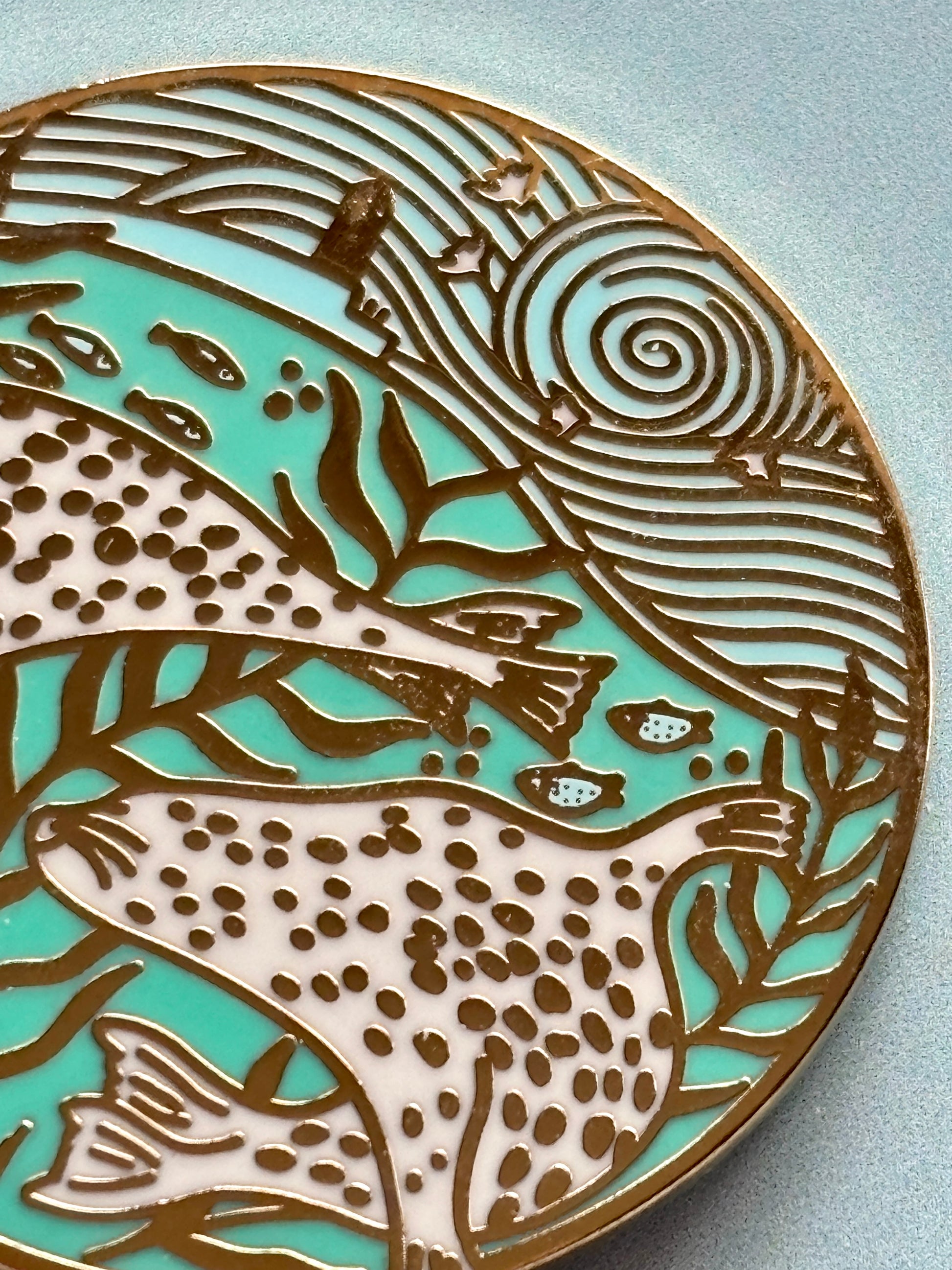 closeup shot of harbour seals enamel pin with gold coastal details, dreamy sea scene for ocean lovers and artistic pin collectors