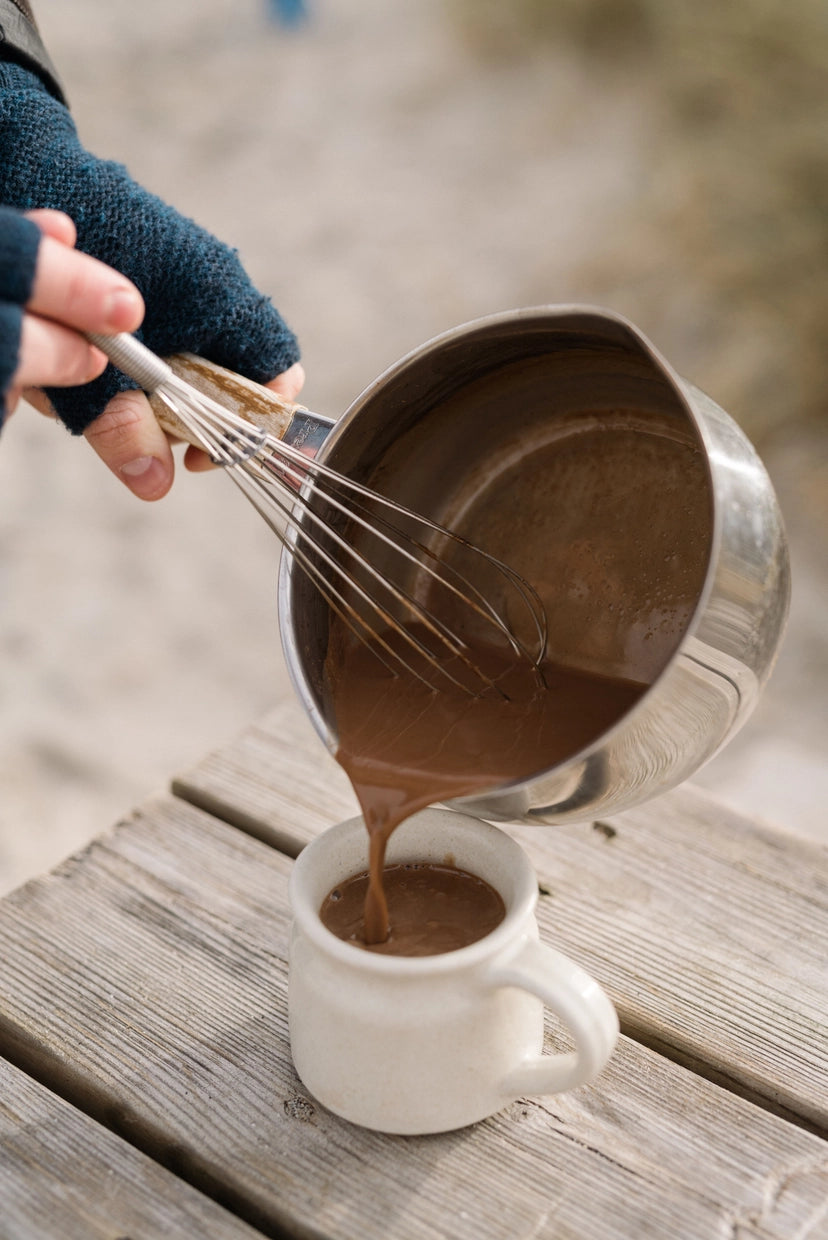 cozy hot chocolate moment—harth 400g artisan blend, handmade with whisk, mug, and winter warmth outdoors