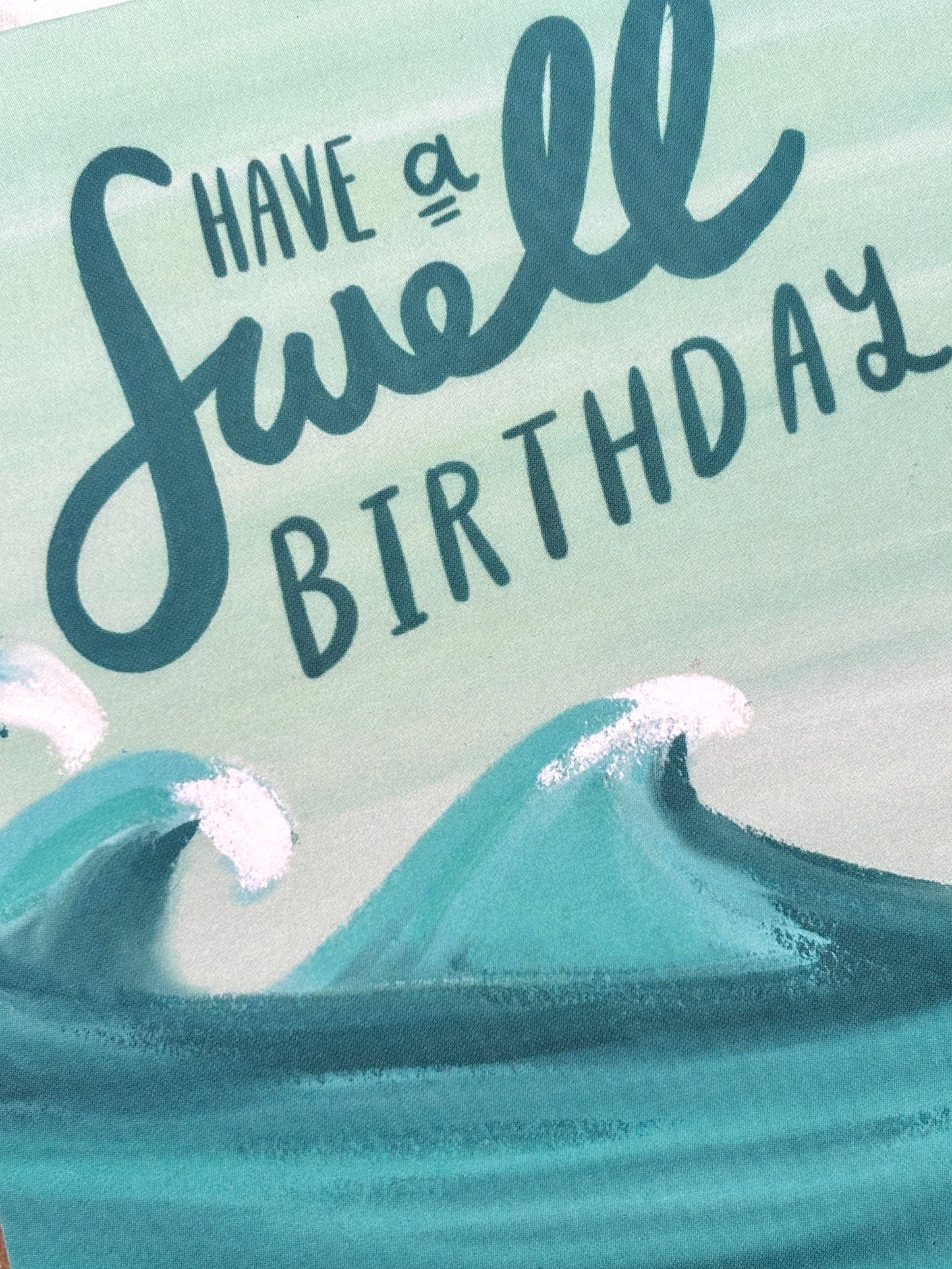 ocean-themed birthday card—“swell” wave pun in cursive, handmade coastal stationery with playful beach vibes
