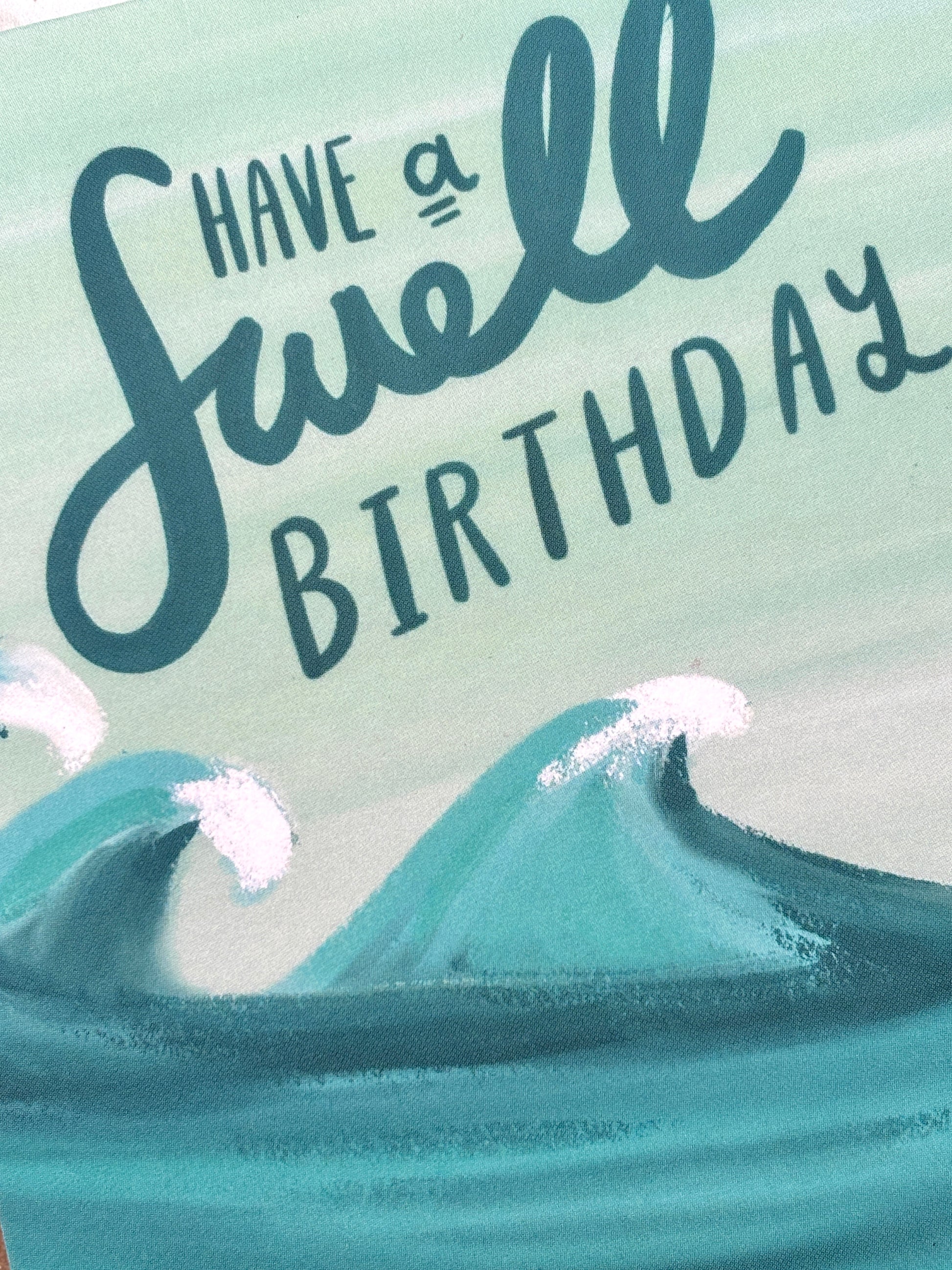 ocean-themed birthday card—“swell” wave pun in cursive, handmade coastal stationery with playful beach vibes