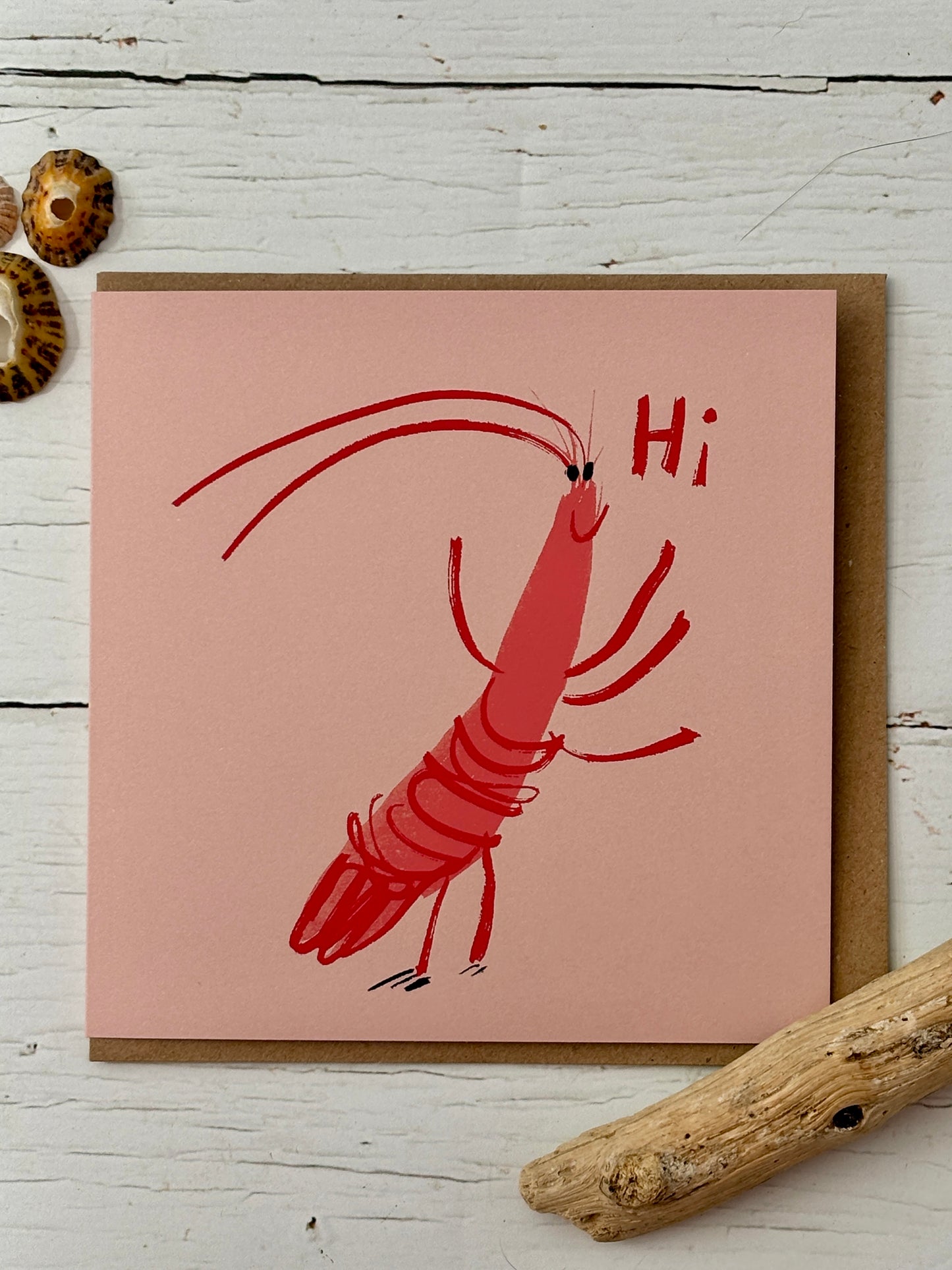 whimsical prawn greeting card—playful cartoon shrimp saying “Hi,” coastal-themed stationery with seashell accents