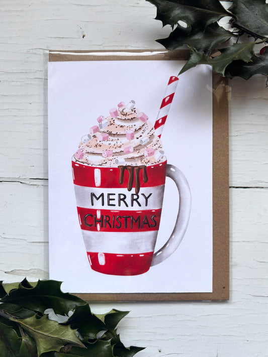 festive Christmas card with hot chocolate mug, whipped cream, candy cane straw, and holiday marshmallows—perfect seasonal gift