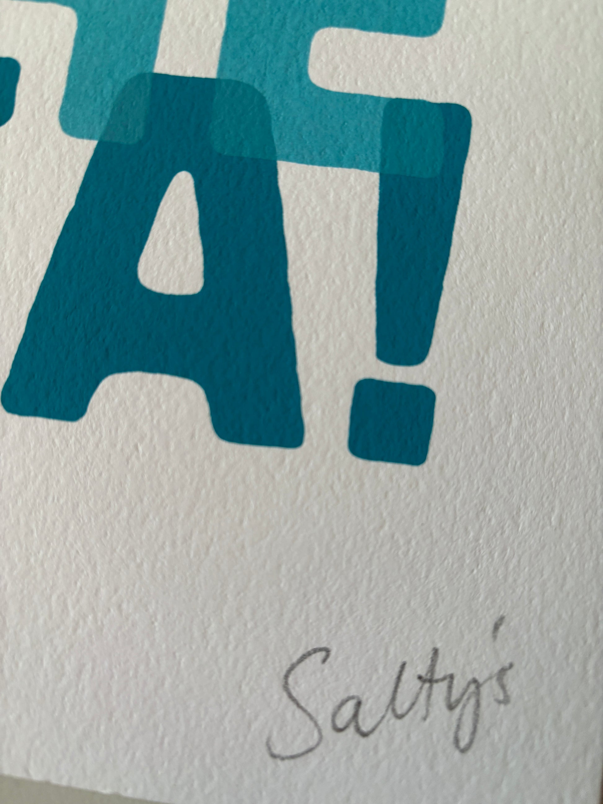 closeup shot of “I Can See the Sea” A4 print—handwritten Salty’s signature, bold coastal typography on textured paper