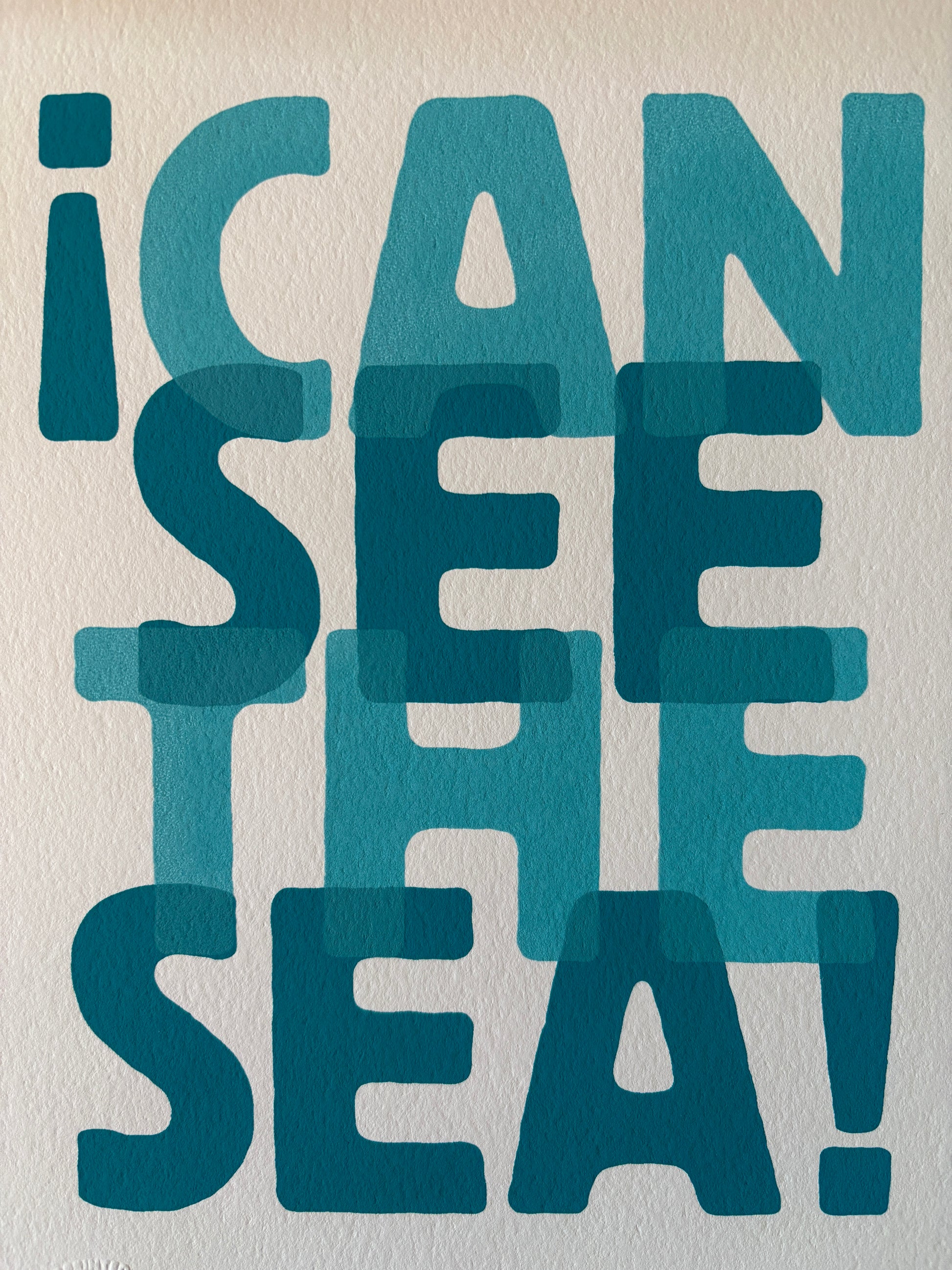 closeup shot of “I Can See the Sea” A4 print—layered blue typography, bold coastal wall art for beach lovers