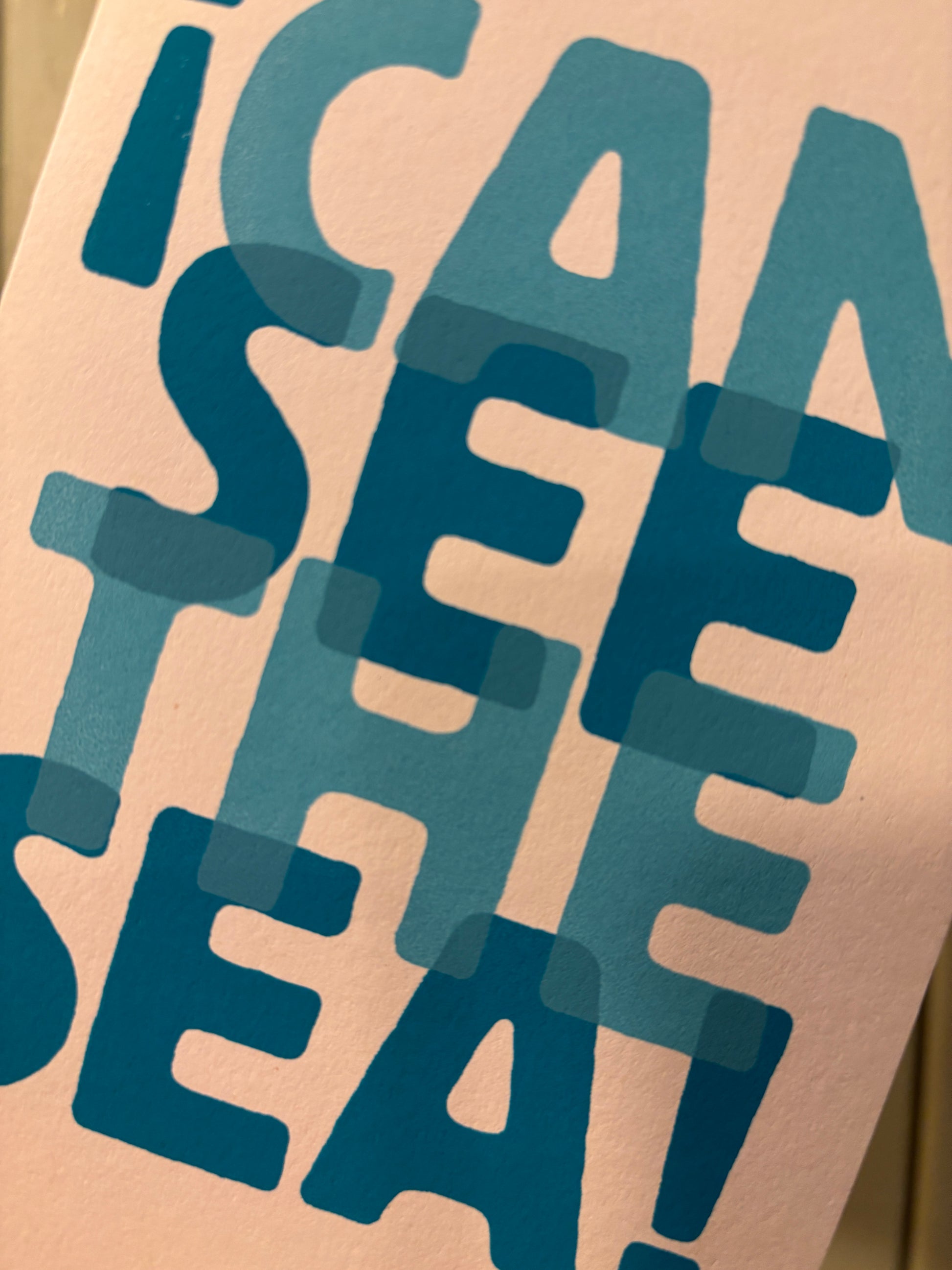 closeup shot of “I Can See the Sea” card—layered blue text on pink, playful coastal stationery with bold typography