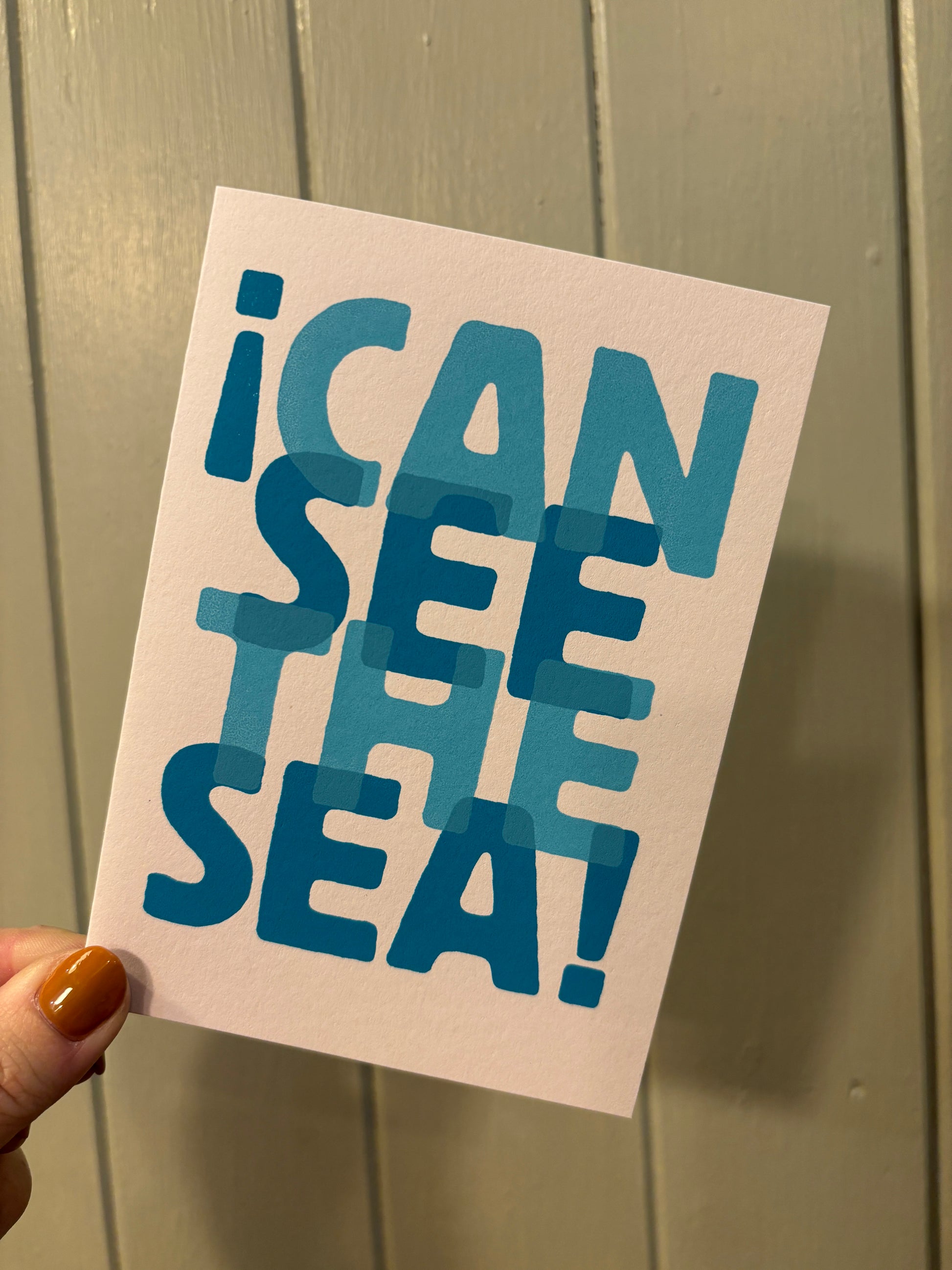 playful seaside greeting card—bold blue “I Can See the Sea” text, fun typography for ocean-themed gifting