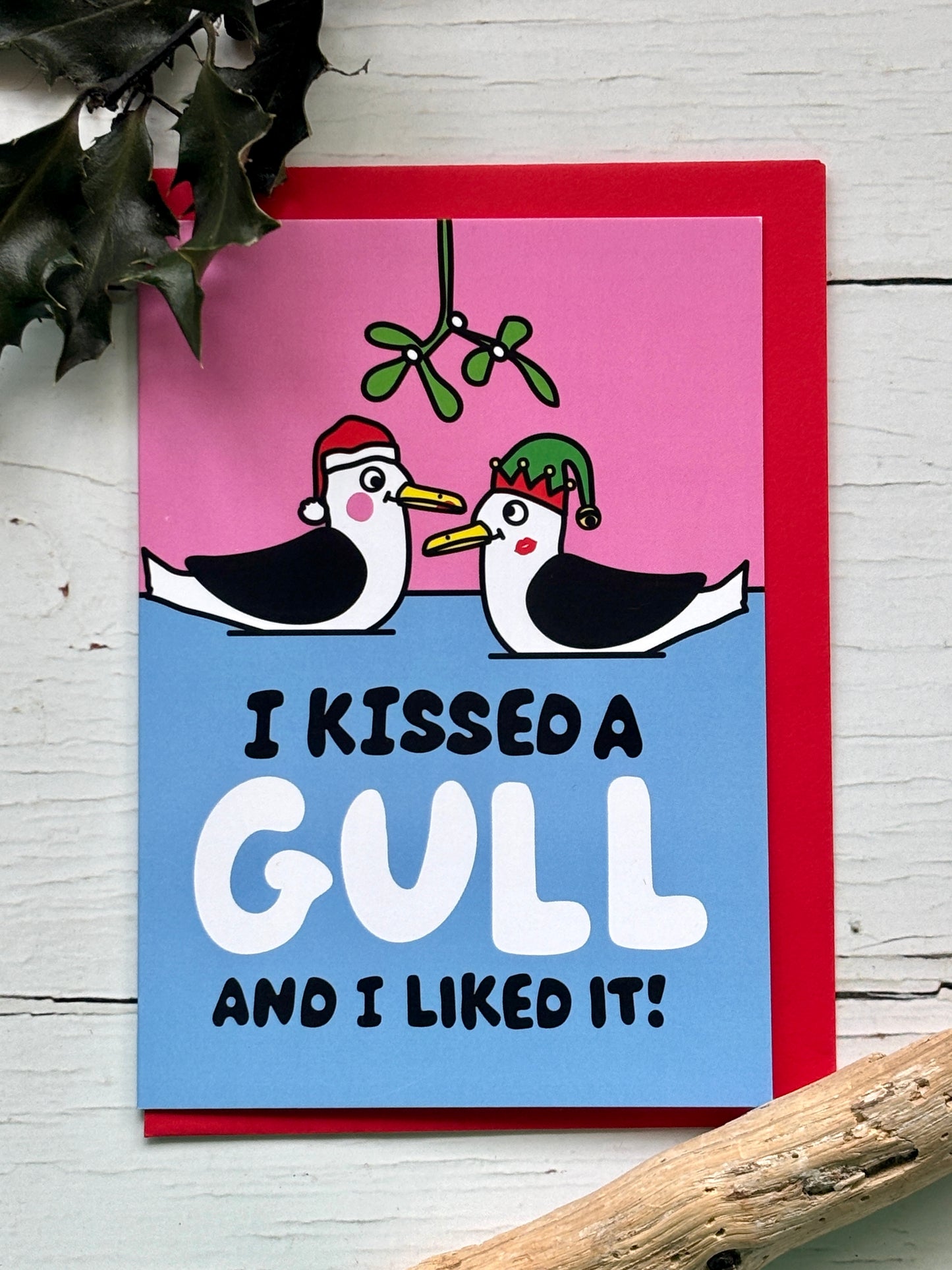 funny Christmas card featuring kissing gulls under mistletoe, playful seaside illustration, humorous festive greeting card
