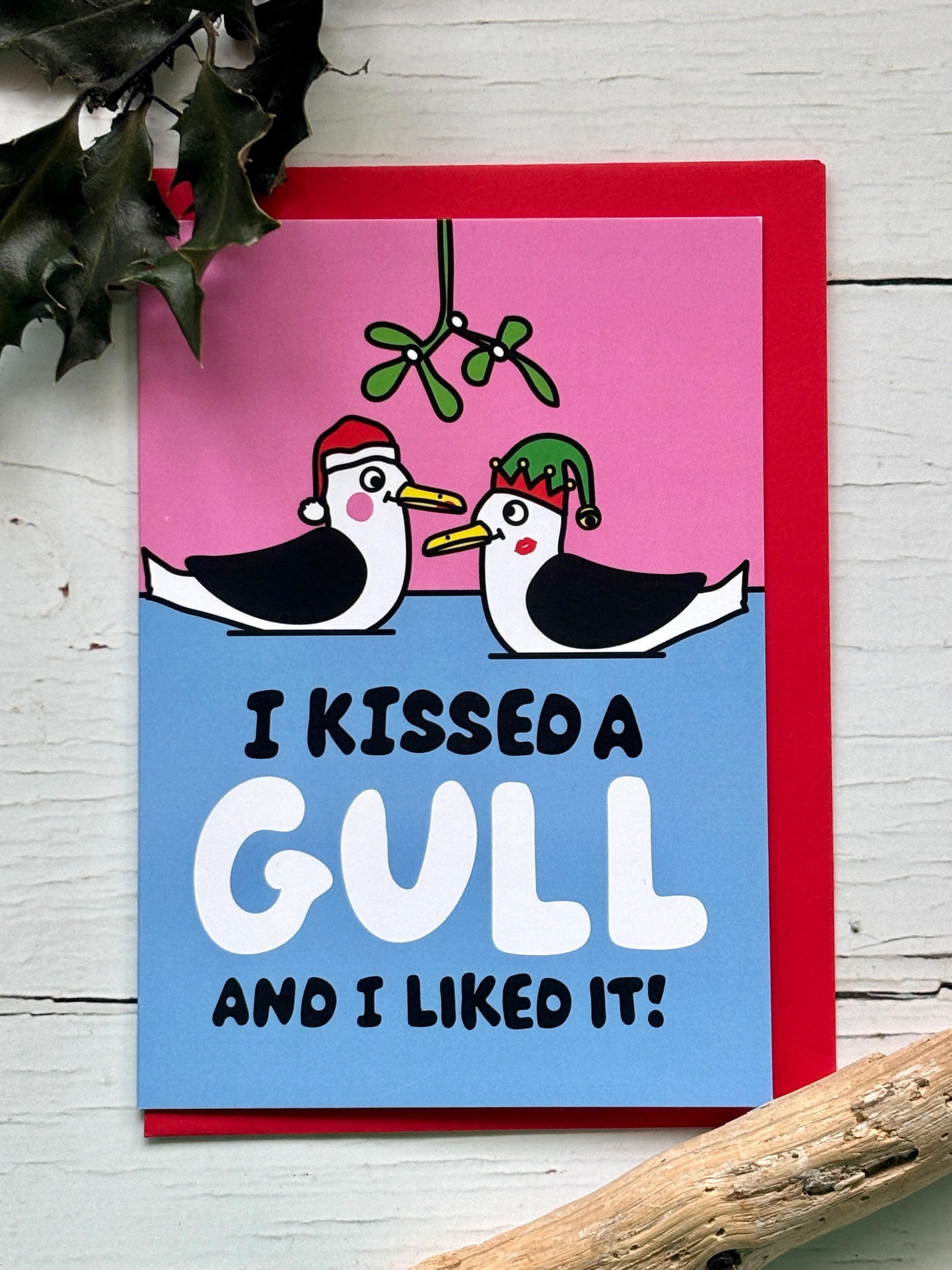 funny Christmas card featuring kissing gulls under mistletoe, playful seaside illustration, humorous festive greeting card