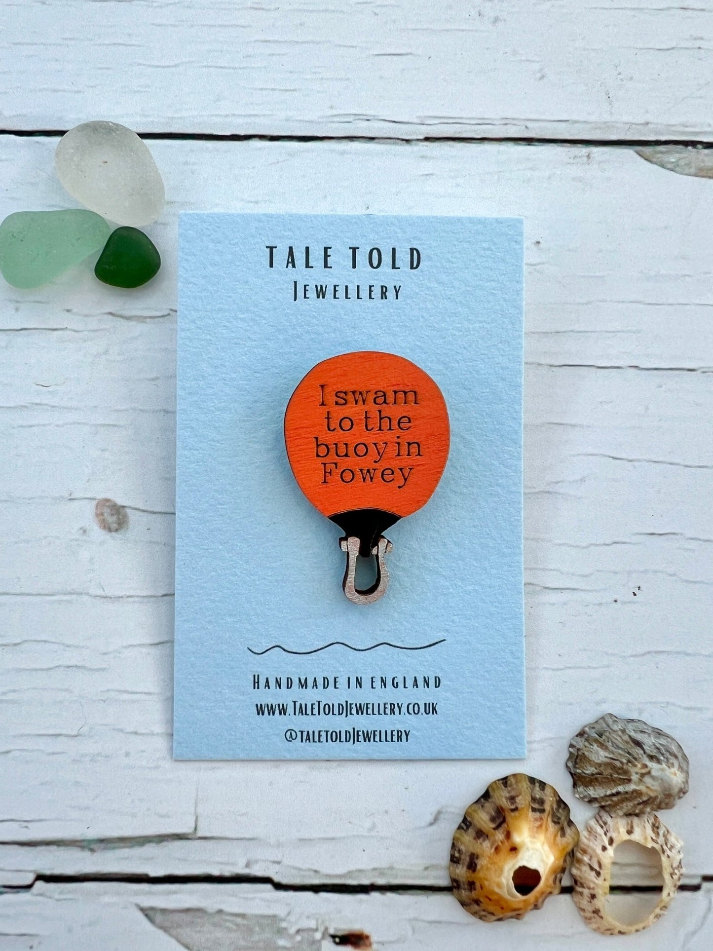 handmade orange buoy-shaped wooden pin badge with “I swam to the buoy in Fowey”—quirky coastal gift, UK-made keepsake