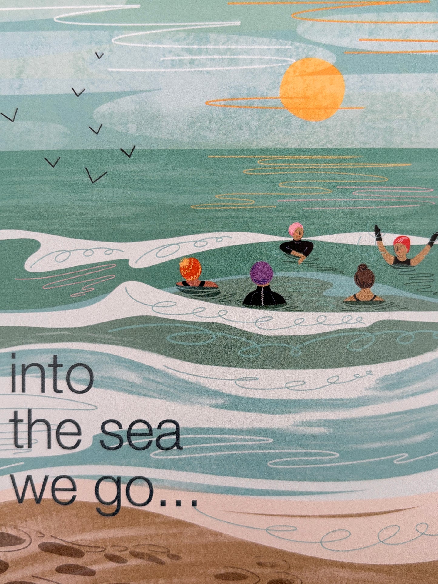 closeup shot of beach greeting card with swimmers and sunset—handmade coastal stationery, summer gift for ocean lovers