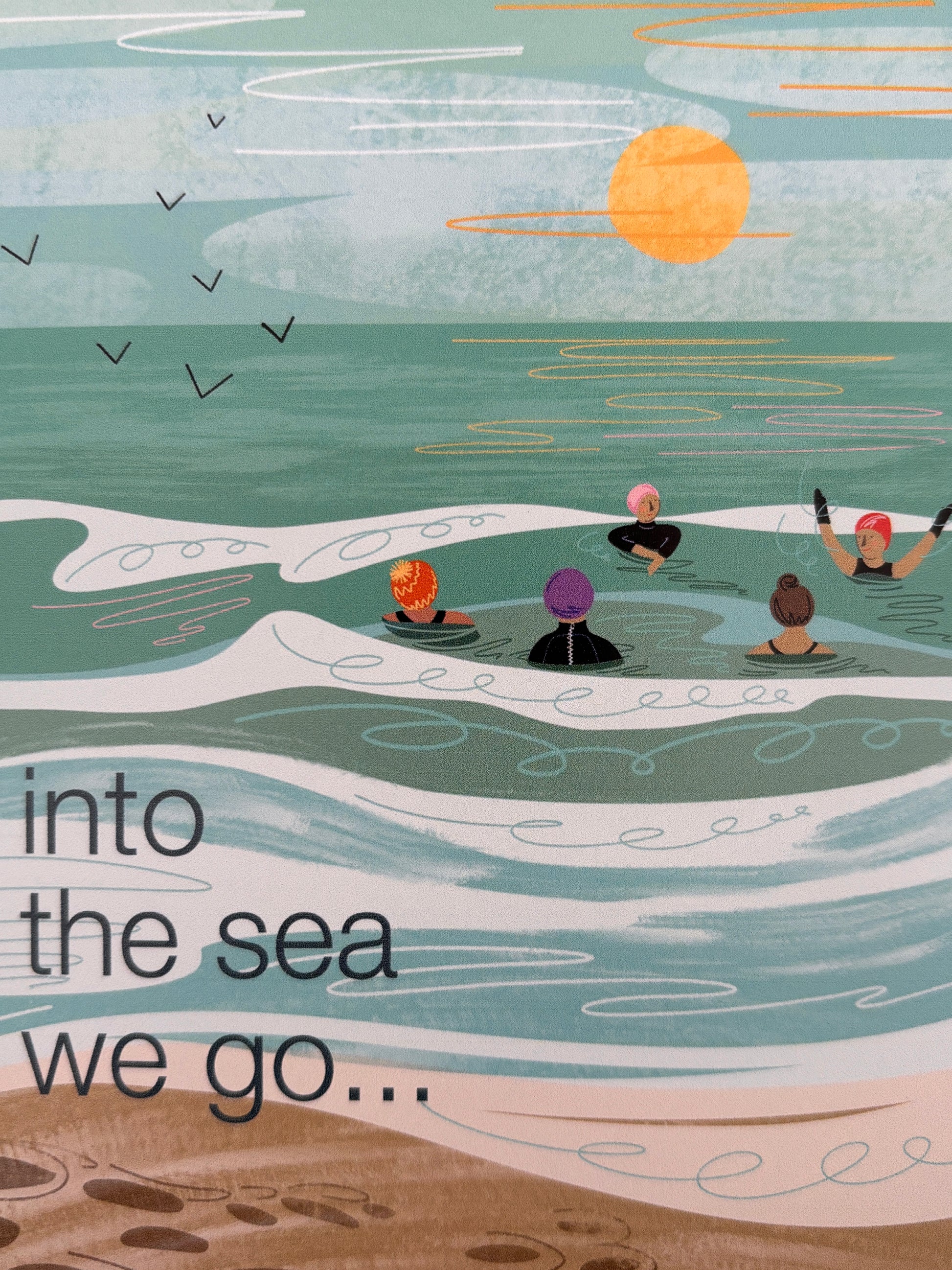 closeup shot of beach greeting card with swimmers and sunset—handmade coastal stationery, summer gift for ocean lovers