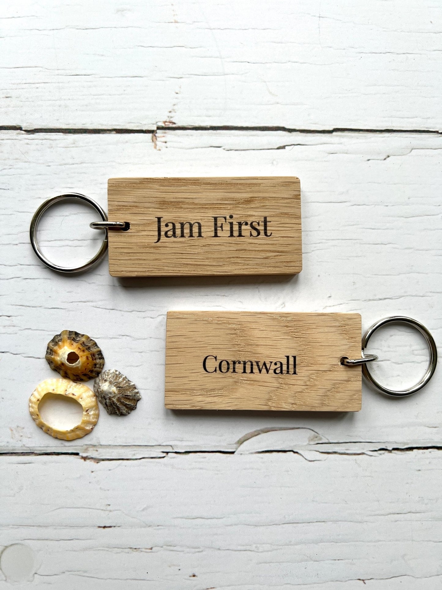 wooden key rings engraved with “Jam First” and “Cornwall”—handmade coastal accessories, perfect gift for cream tea lovers