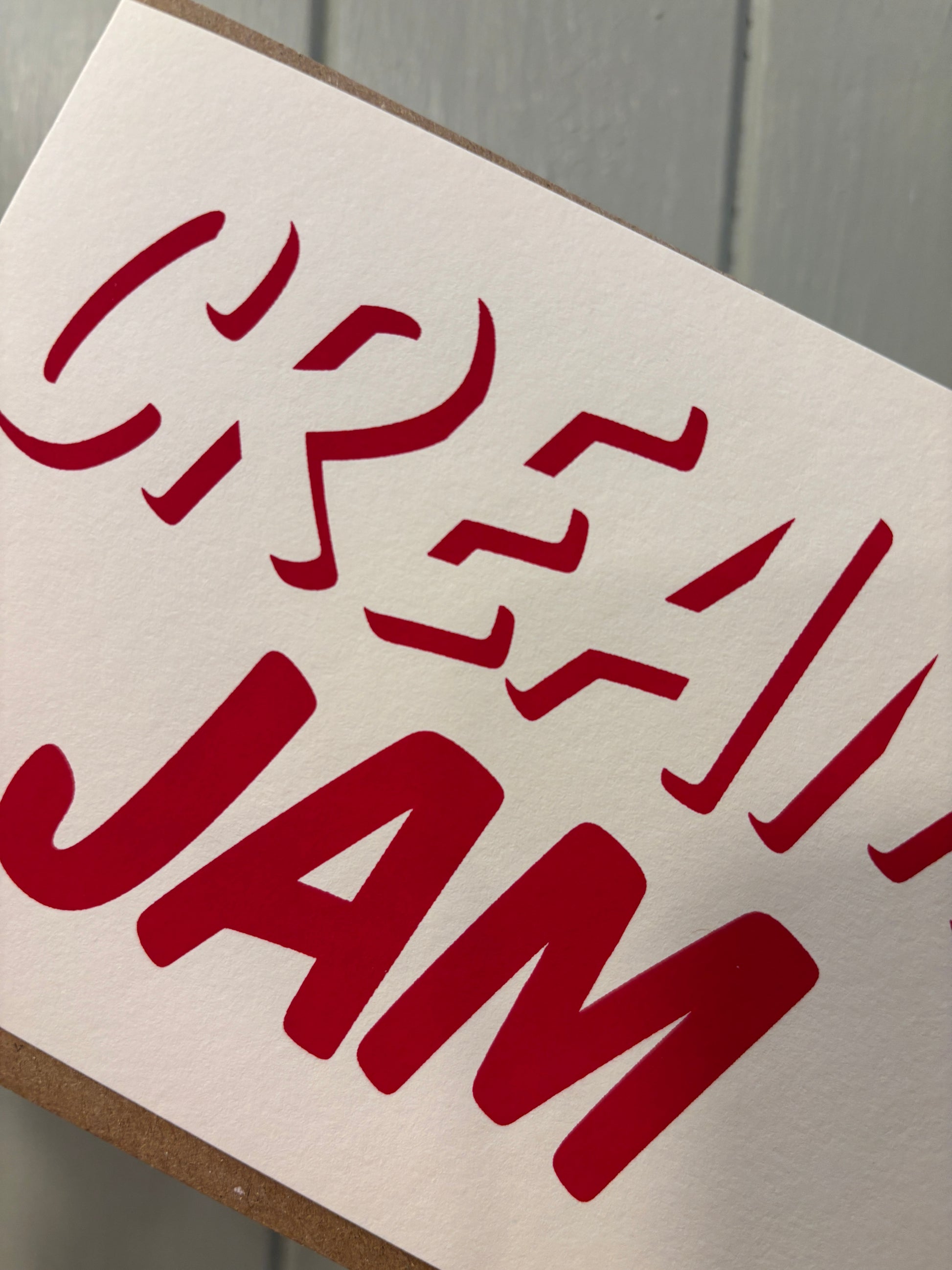 closeup shot of bold red “CREAM JAM” card—handmade minimalist foodie stationery, quirky gift for jam-first cream tea fans