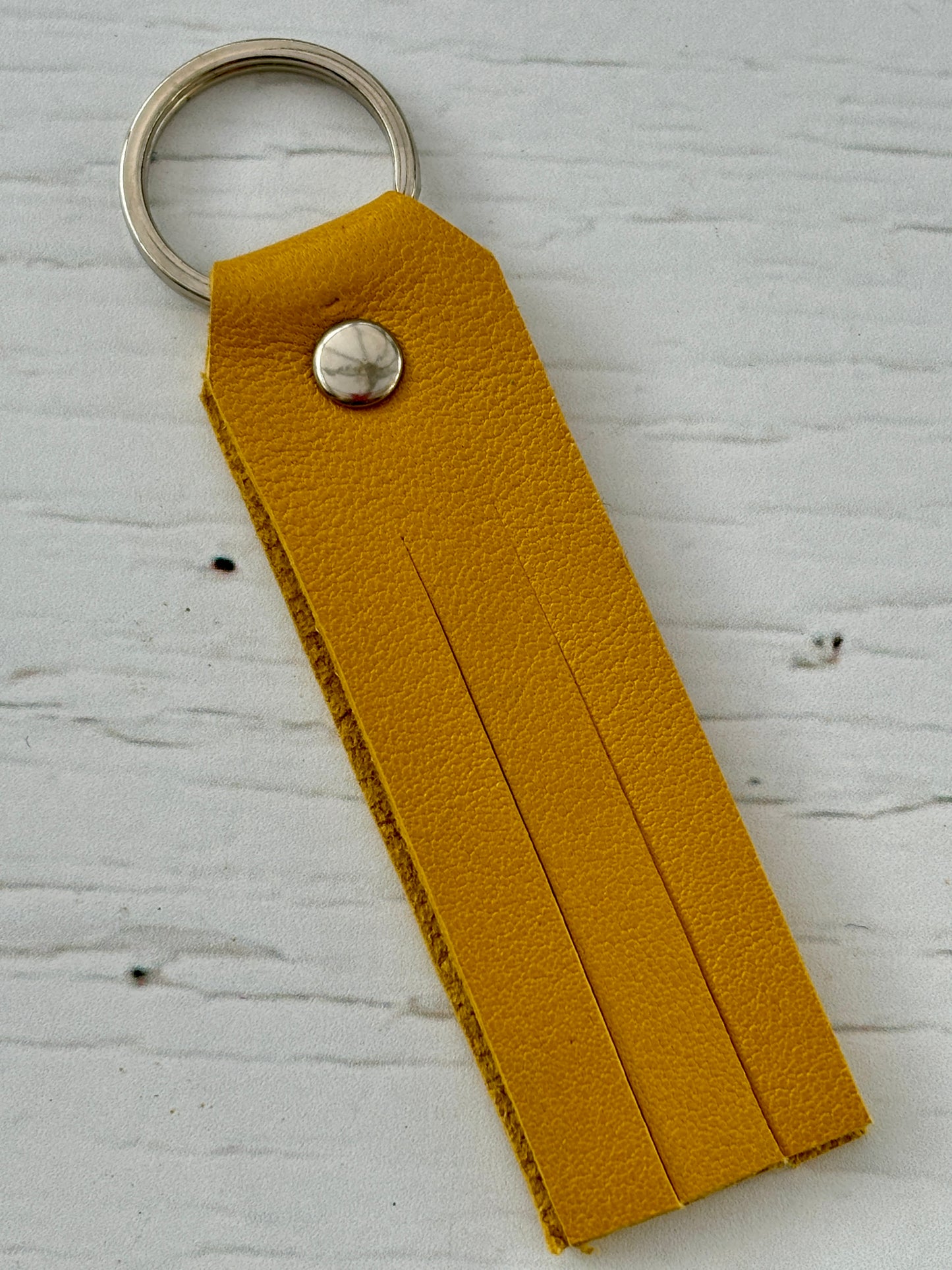 matte yellow key fob—super soft leather offcut with fringe detail, lightweight, bold, and perfect for daily essentials