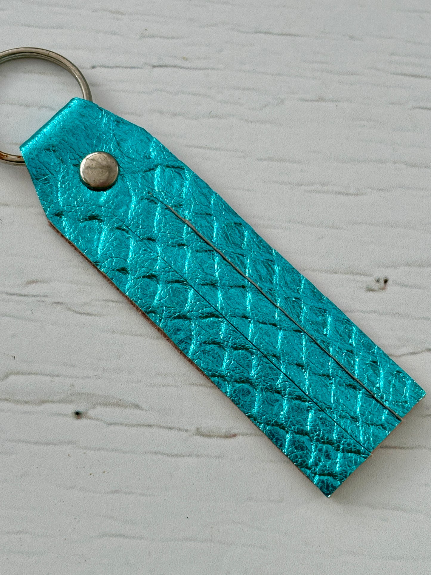 metallic turquoise key fob—super soft leather offcut with fringe detail, bold texture, and lightweight everyday style