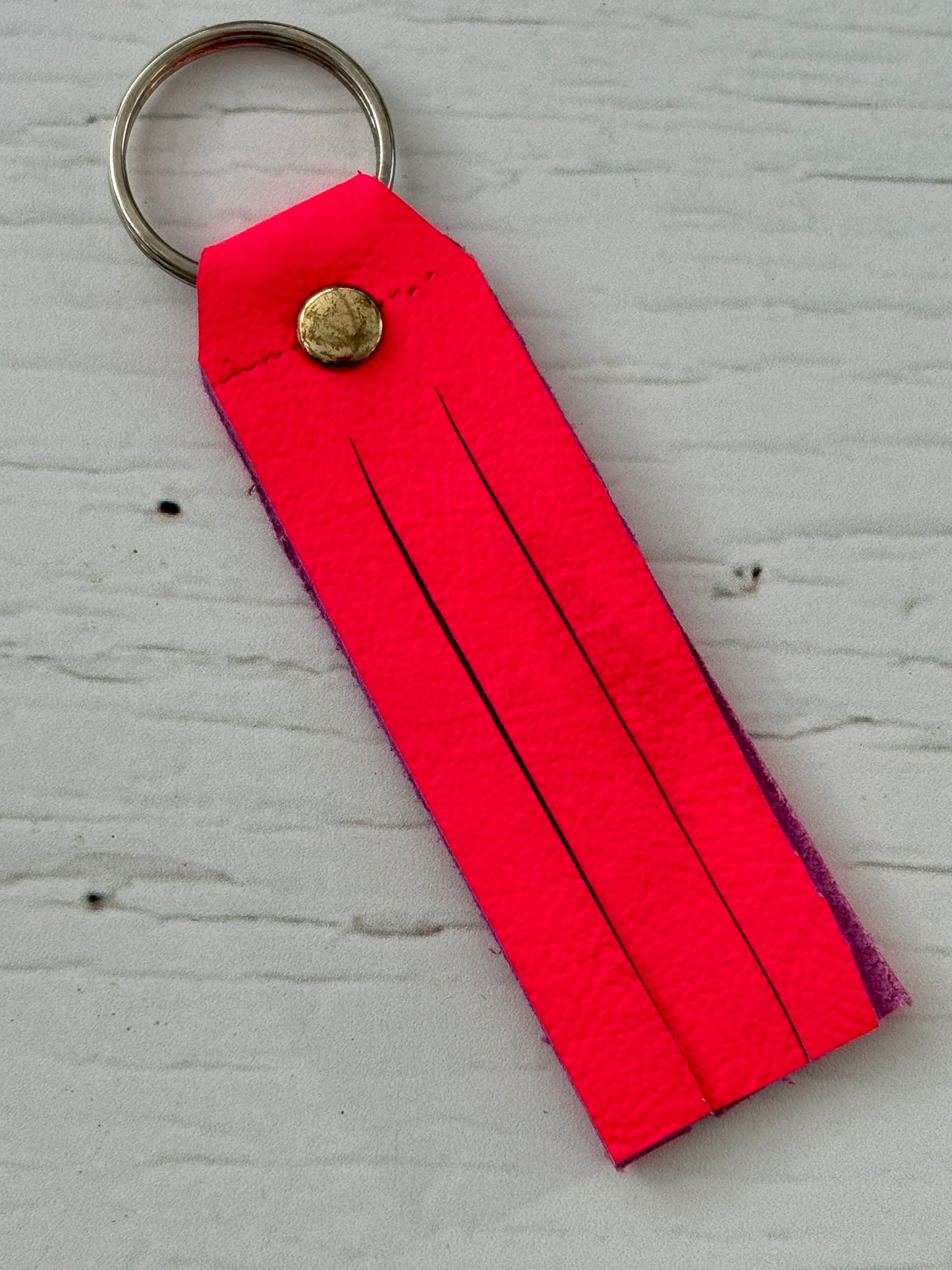 neon pink key fob—super soft leather offcut, fringe detail, bold and lightweight for vibrant everyday carry