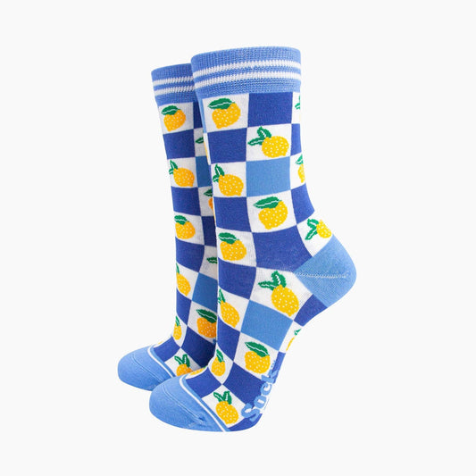 a pair of blue checkerboard socks with lemon design
