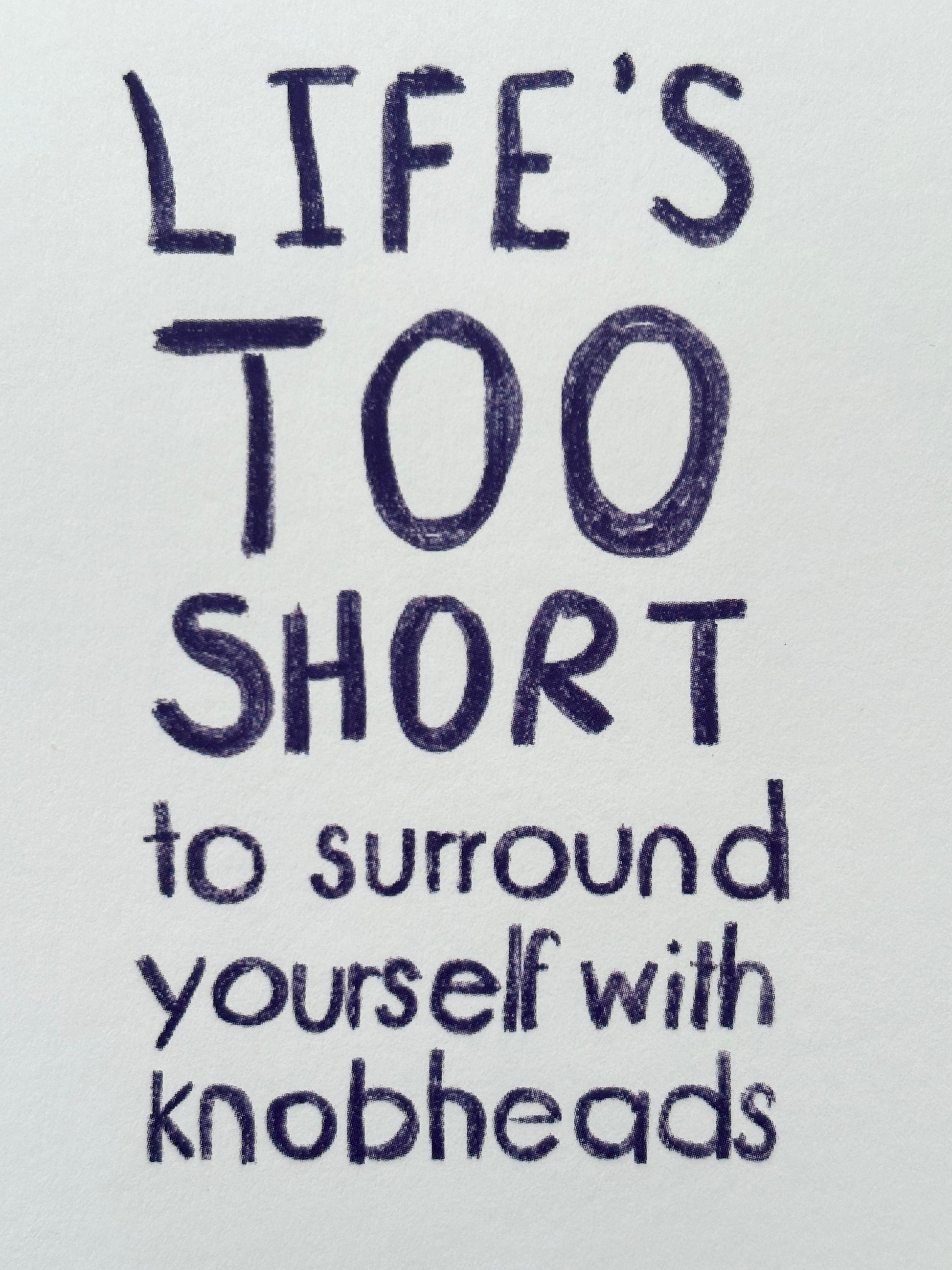 closeup shot of sweary quote 'Life's too short to surround yourself with knobheads' funny, offensive, humor greeting card text