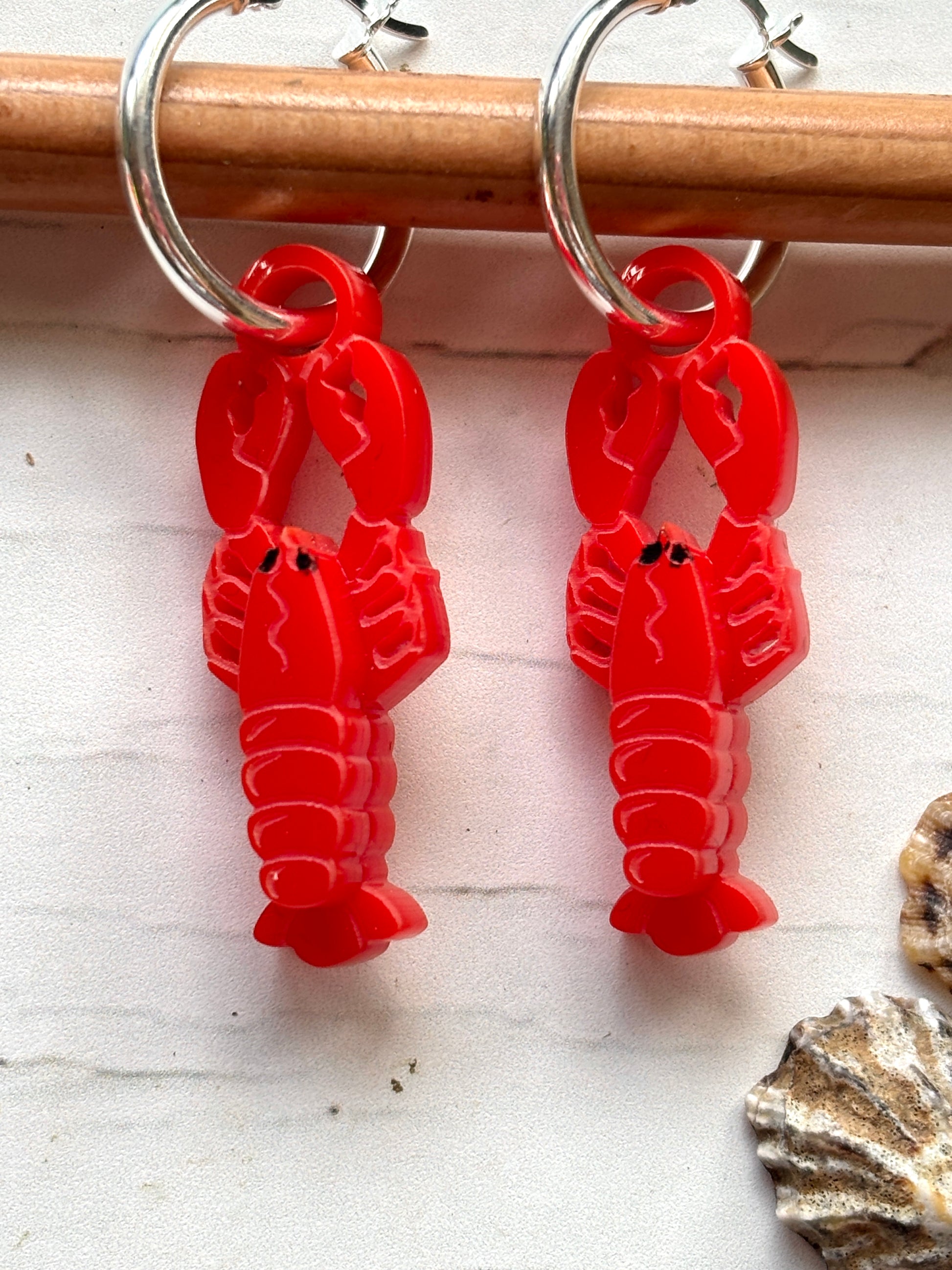 lobster earrings—glossy red crustacean charms on silver hoops, perfect for coastal fashion, beachwear, and ocean-inspired gifting