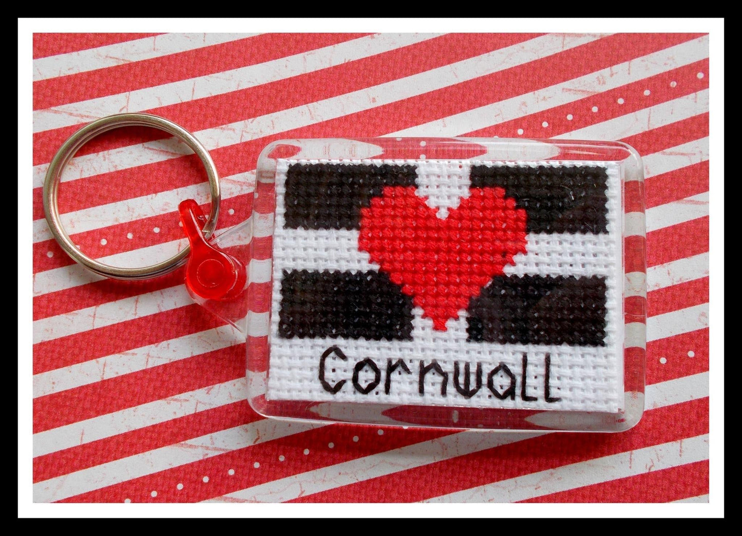 closeup shot of Cornwall cross stitch keyring—handmade heart design, perfect coastal gift for craft lovers and UK travel fans