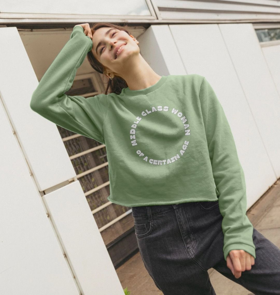 sage green cropped sweatshirt lifestyle staircase, middle class woman slogan jumper, relaxed casual fashion, modern fit