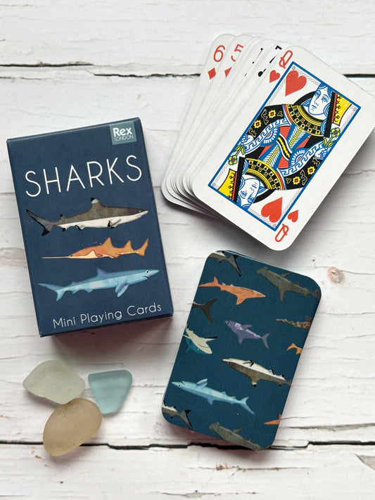 mini shark playing card set featuring illustrated sharks, compact box, sea glass, and Queen of Hearts, perfect for travel games