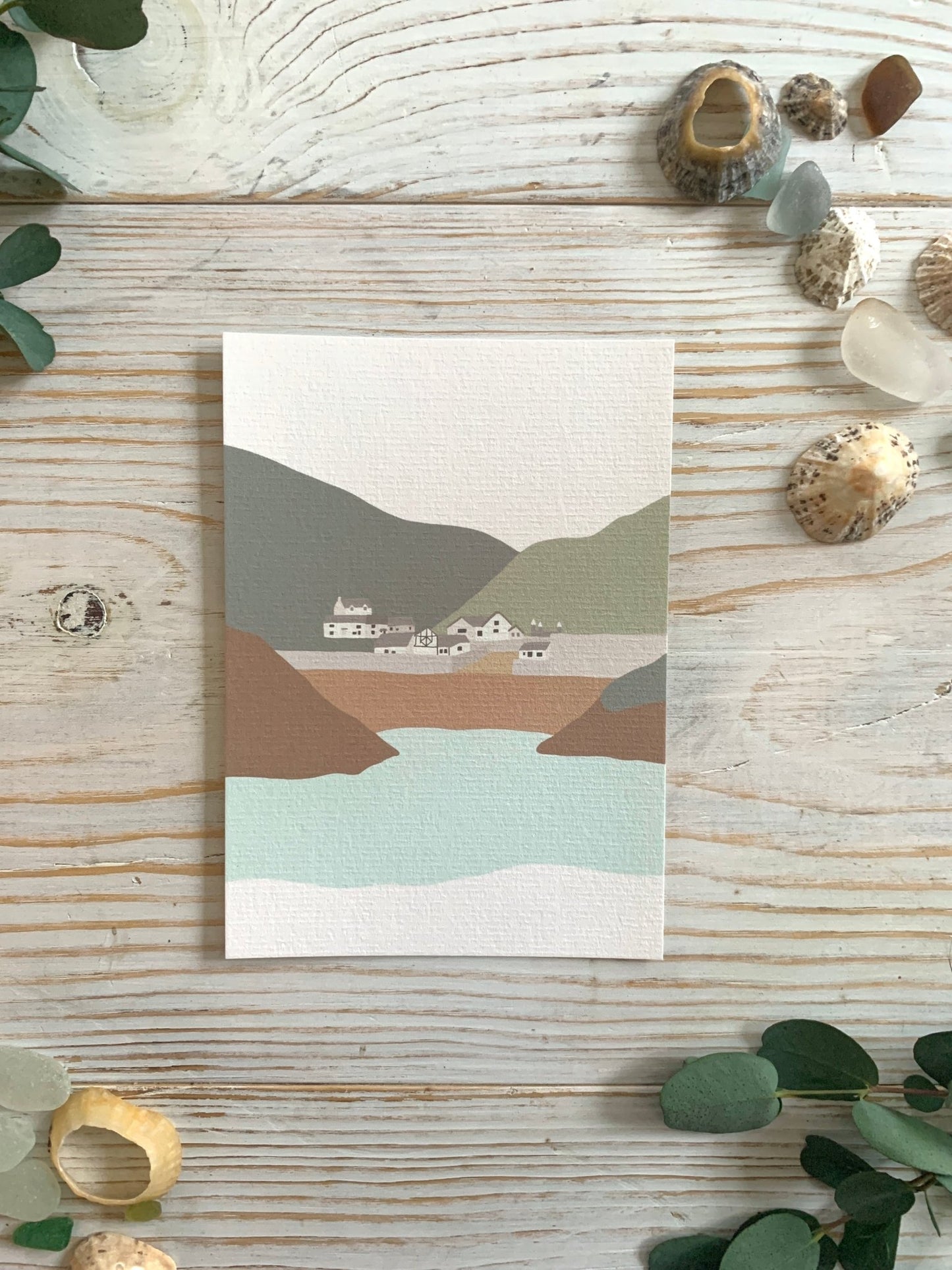 minimalist coastal art postcard with serene cove, village, and mountains—ideal for nature-inspired decor or travel gifting