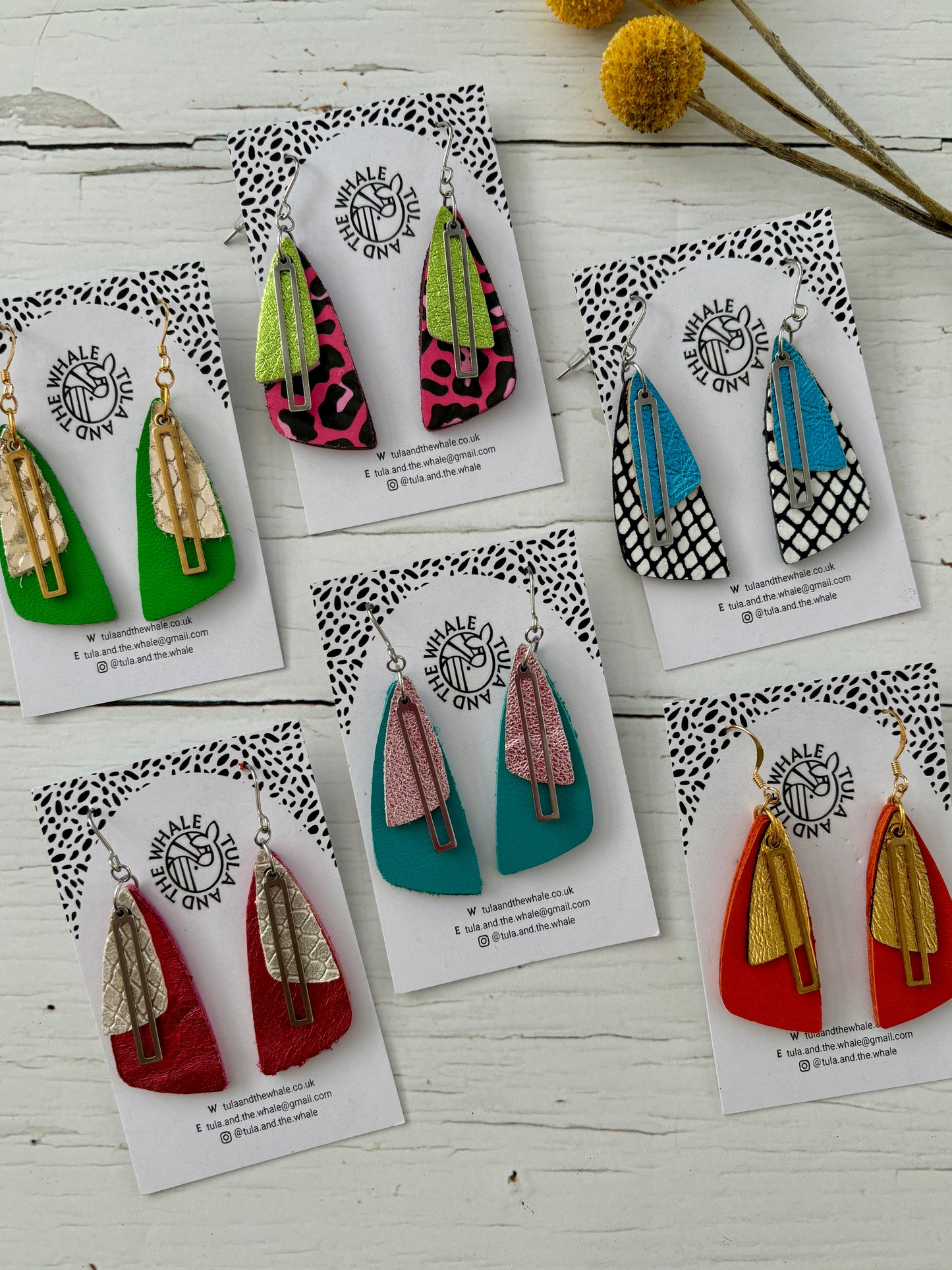 handmade dangly earrings with layered leather in moth-wing shapes—bold, lightweight, and nature-inspired statement jewelry