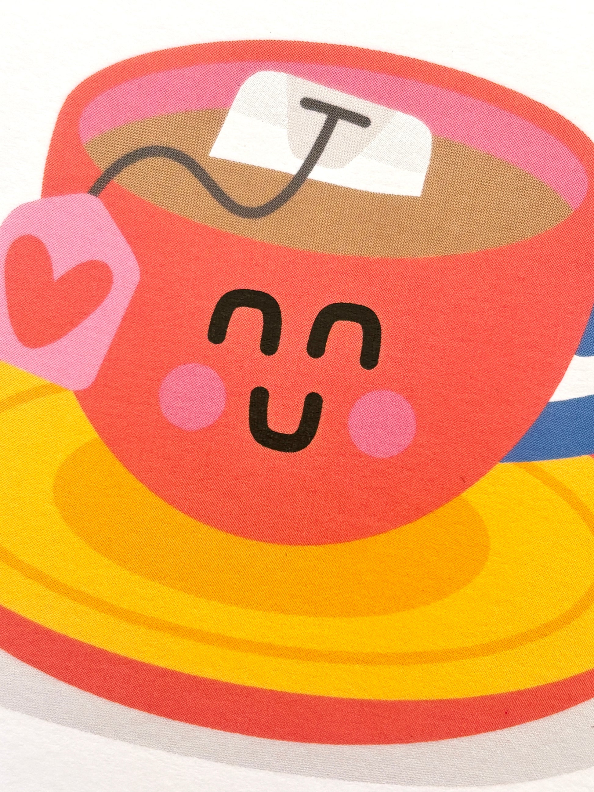 closeup shot of cute Mother's Day card with smiling teacup, heart tag, and pun “Best-Tea”—playful, tea-themed stationery