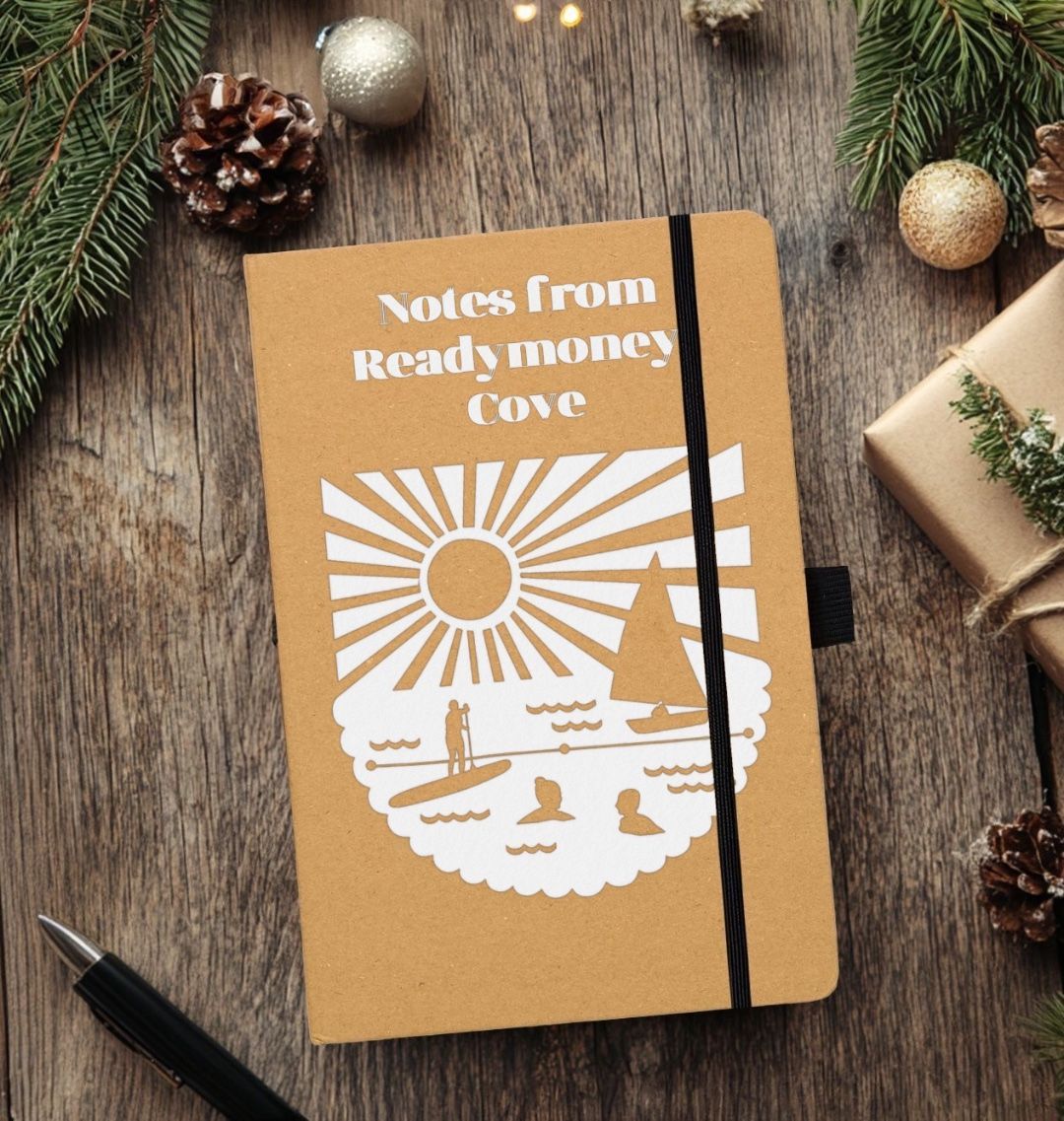 lifestyle shot of recycled Readymoney Cove notebook—eco-friendly, coastal-themed stationery with festive gift appeal