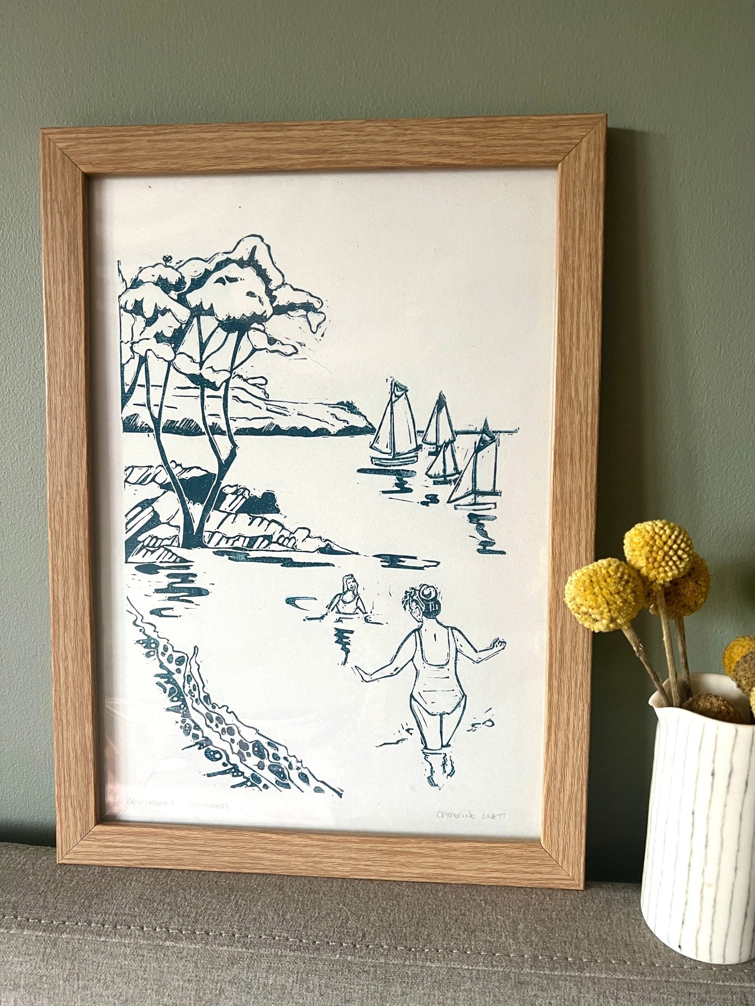 framed lino print in home setting Swimmers at Readymoney Cove, Fowey, Cornwall Catherine Loft coastal wall art decor