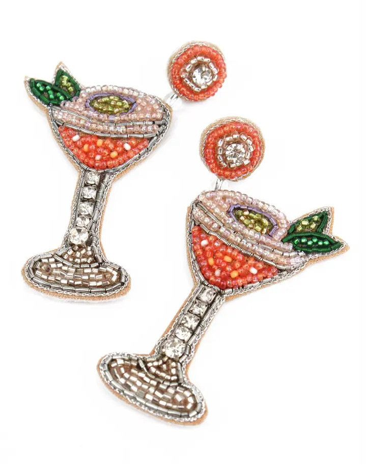 Decorative earrings resembling cocktail glasses with gemstone details on a white background