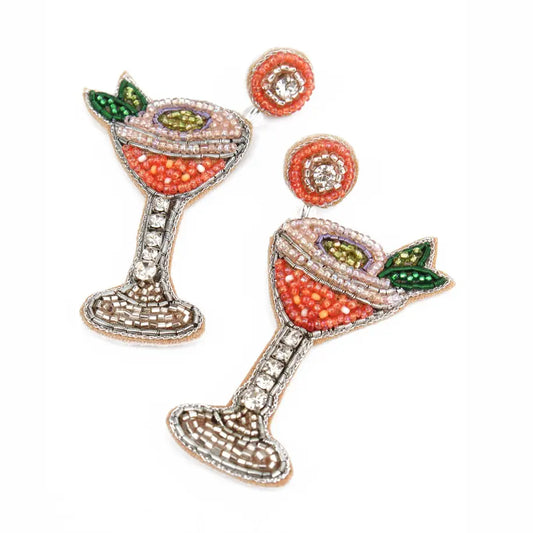 Decorative earrings resembling cocktail glasses with gemstone details on a white background