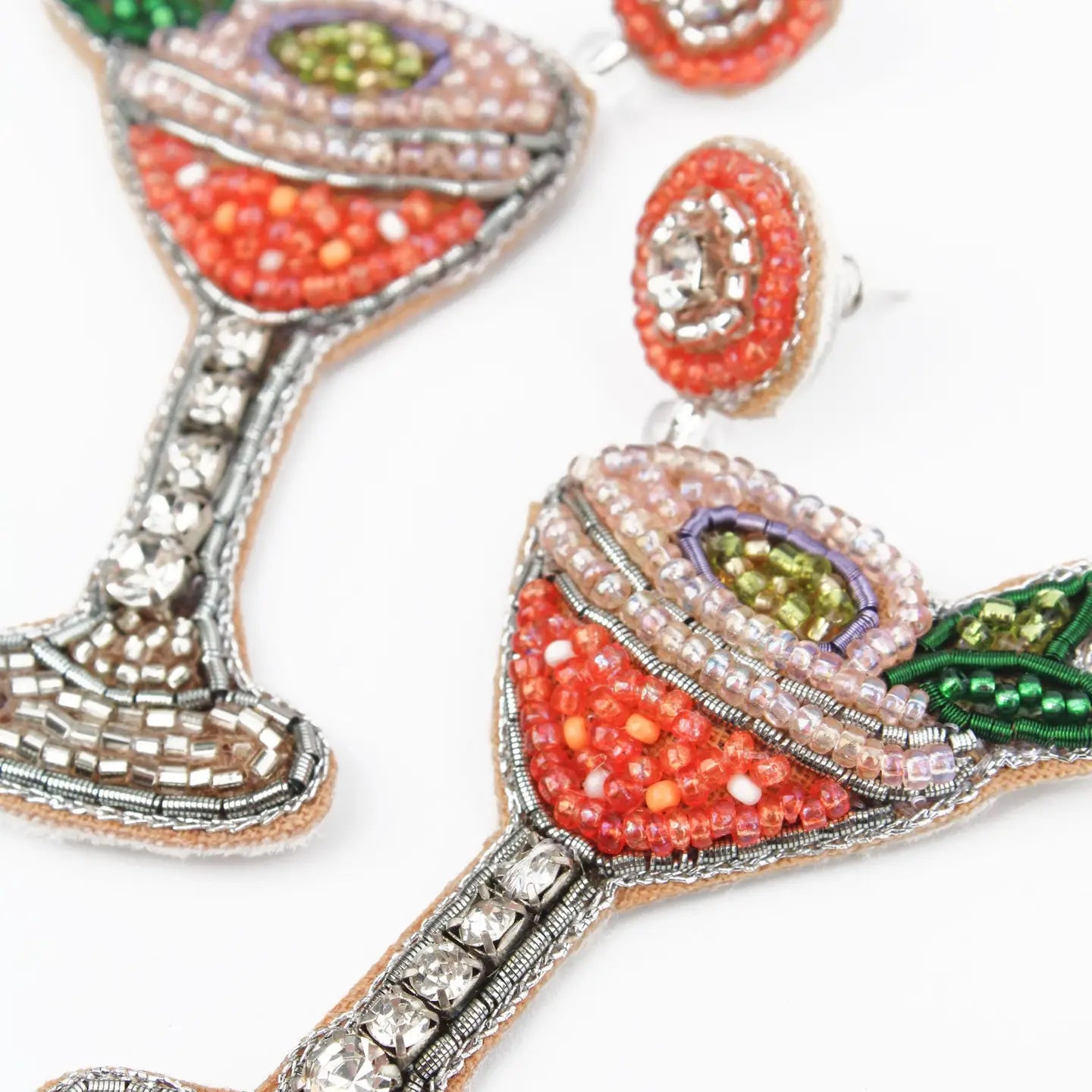 Decorative earrings shaped like cocktail glasses with beaded details on a white background