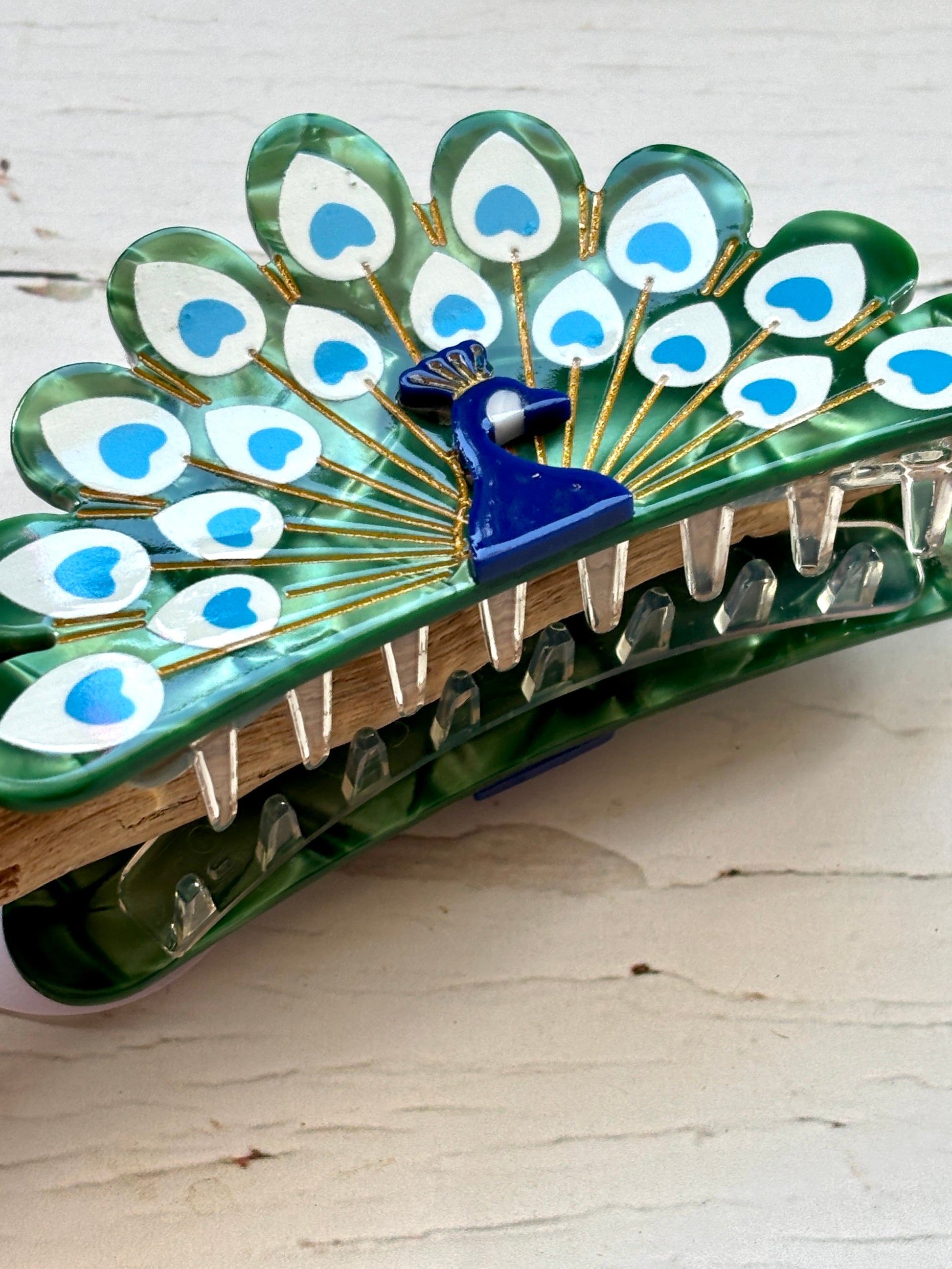 closeup shot of peacock hair claw clip green mosaic acetate fan jaw clip elegant bird statement accessory for thick hair
