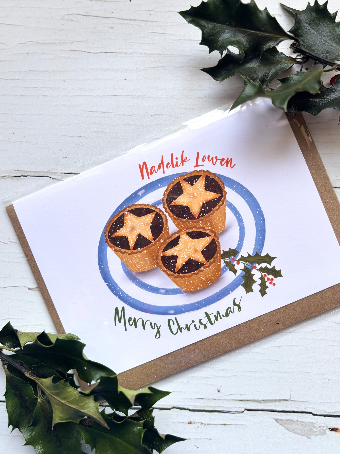 Cornish Christmas card with mince pies on festive plate, holly sprig, and “Nadelik Lowen” greeting—perfect holiday gift