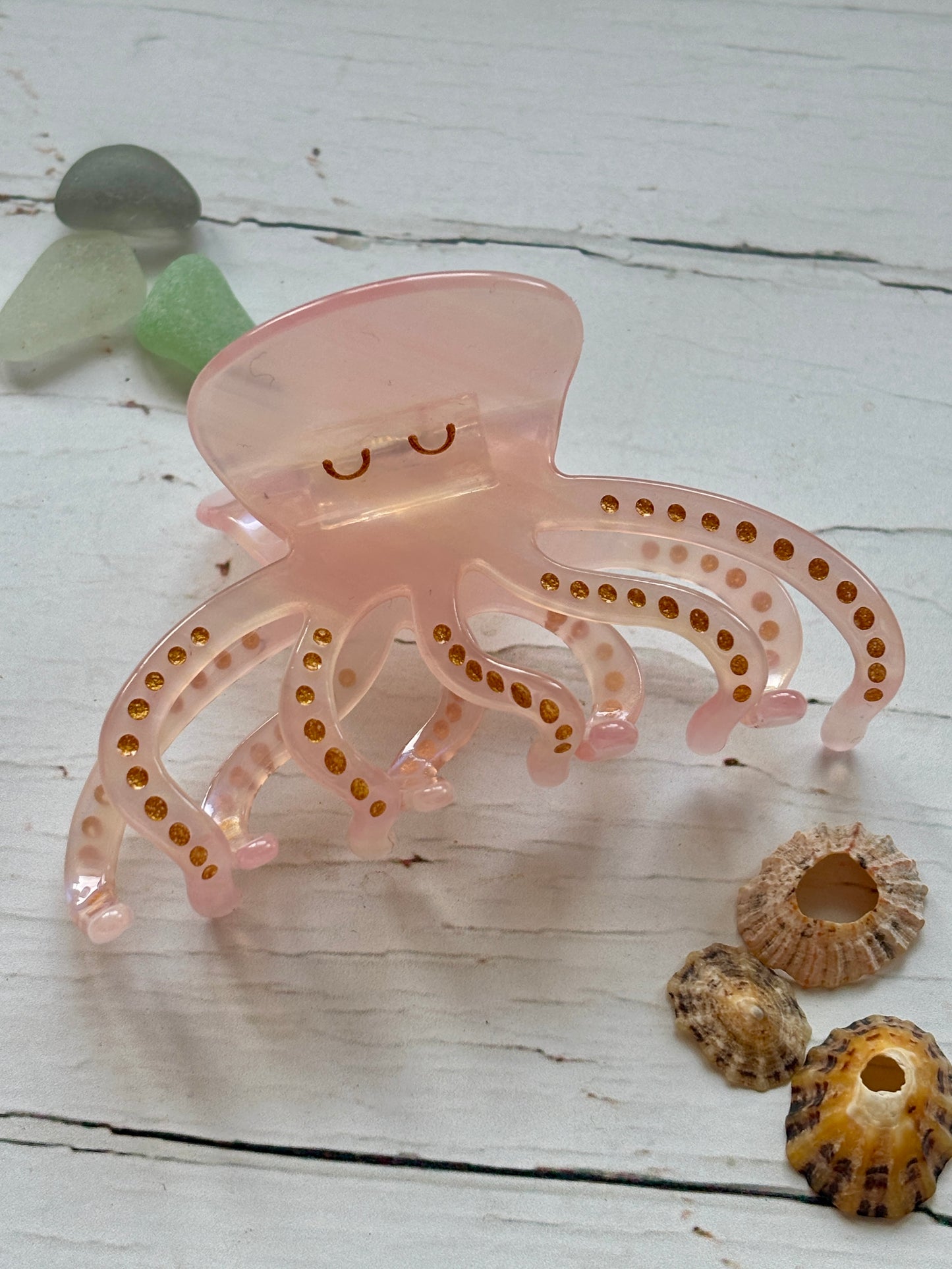Pale pink octopus hair claw clip with gold glitter spots cute sea animal, resin, nautical, beach-themed summer hair accessory.