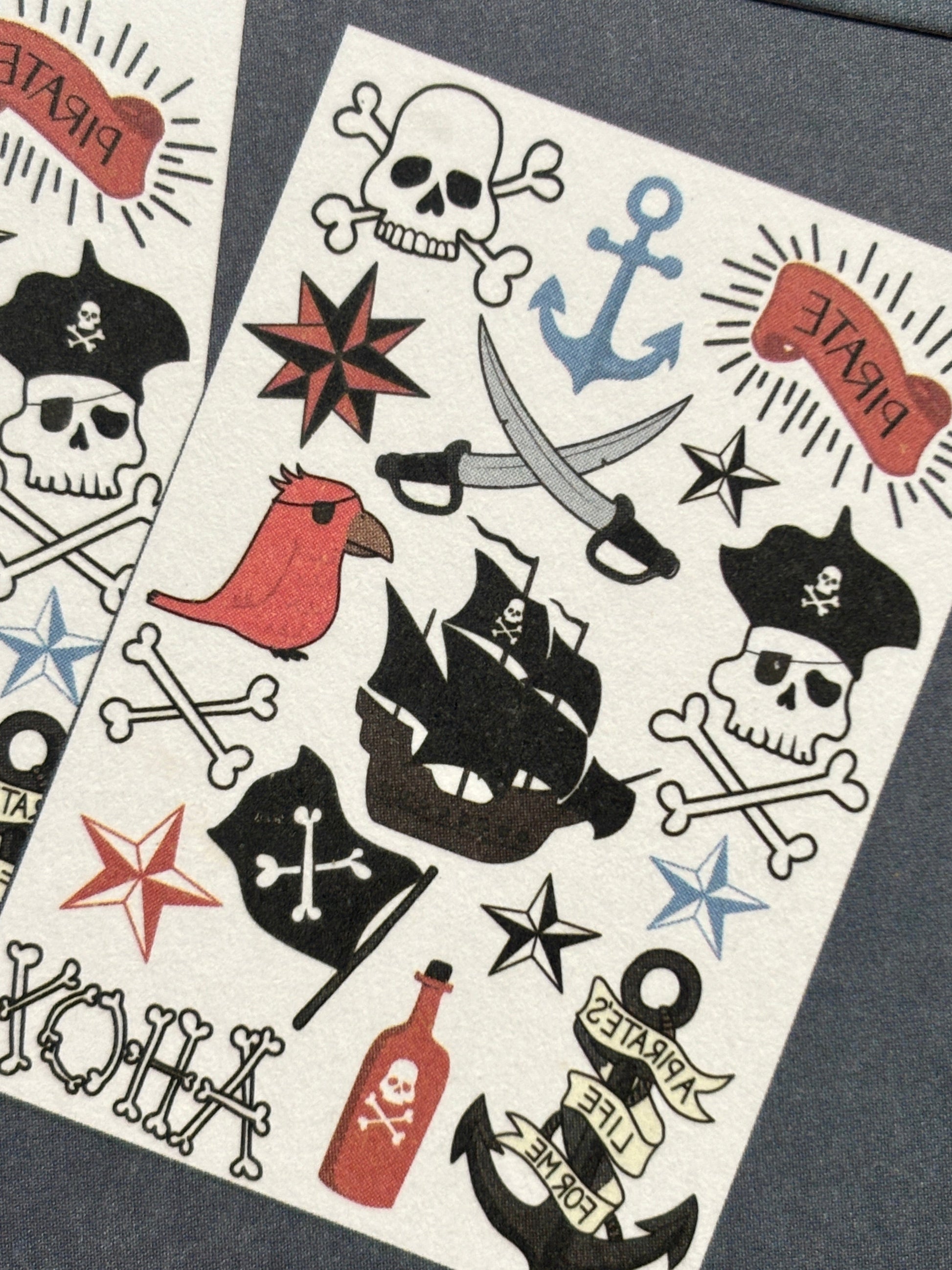 closeup shot of pirate temporary tattoos featuring skulls, ships, swords & slogans—ideal for party favors or costumes