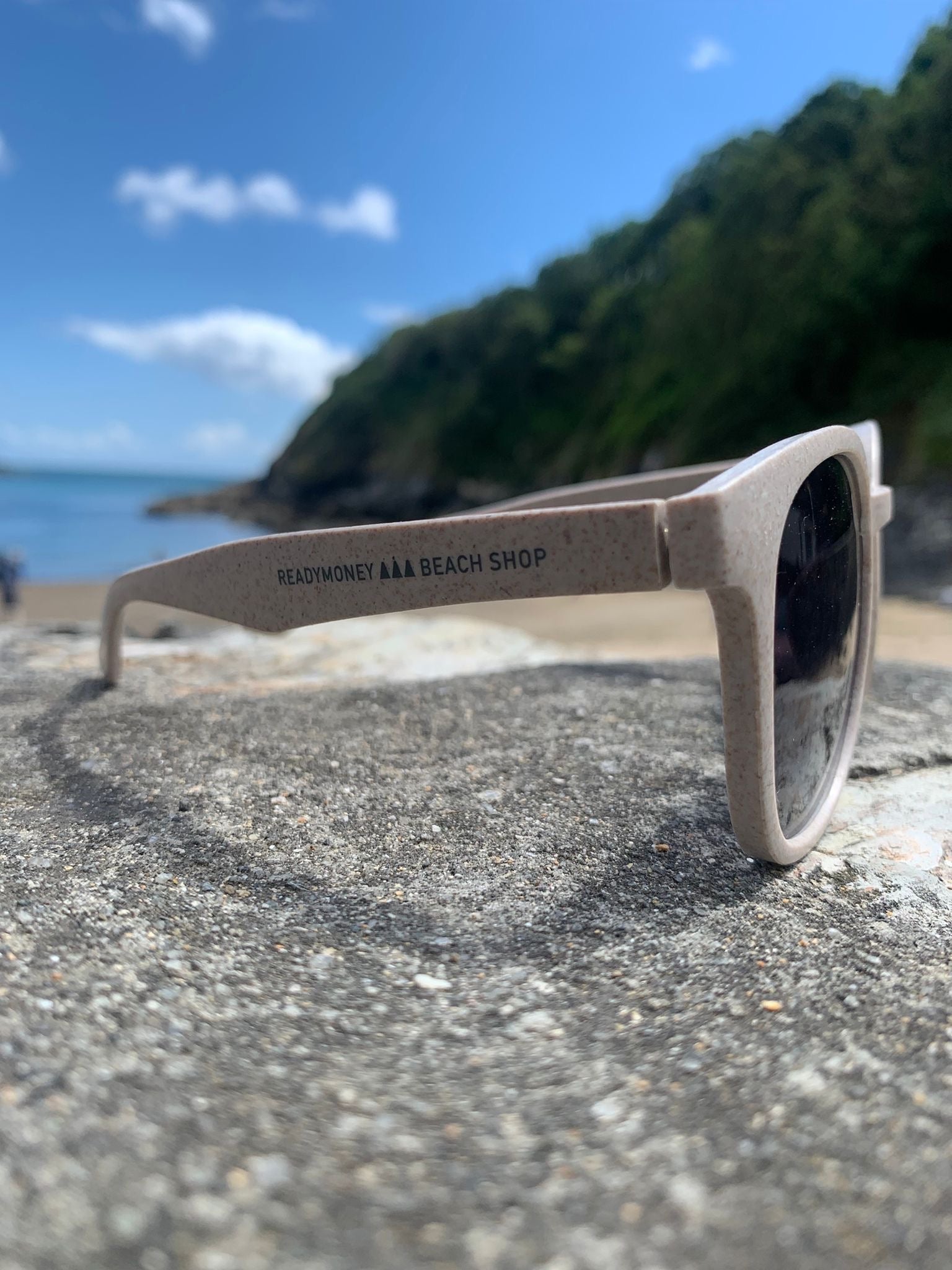 side view of 'Readymoney Beach Shop' eco-friendly sunglasses recycled plastic frame, sustainable, coastal beach eyewear, sunny day