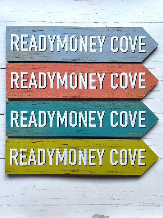 set of four colorful 'Readymoney Cove' coastal direction arrow signs vintage beach wall art decor, blue, orange, teal, lime green