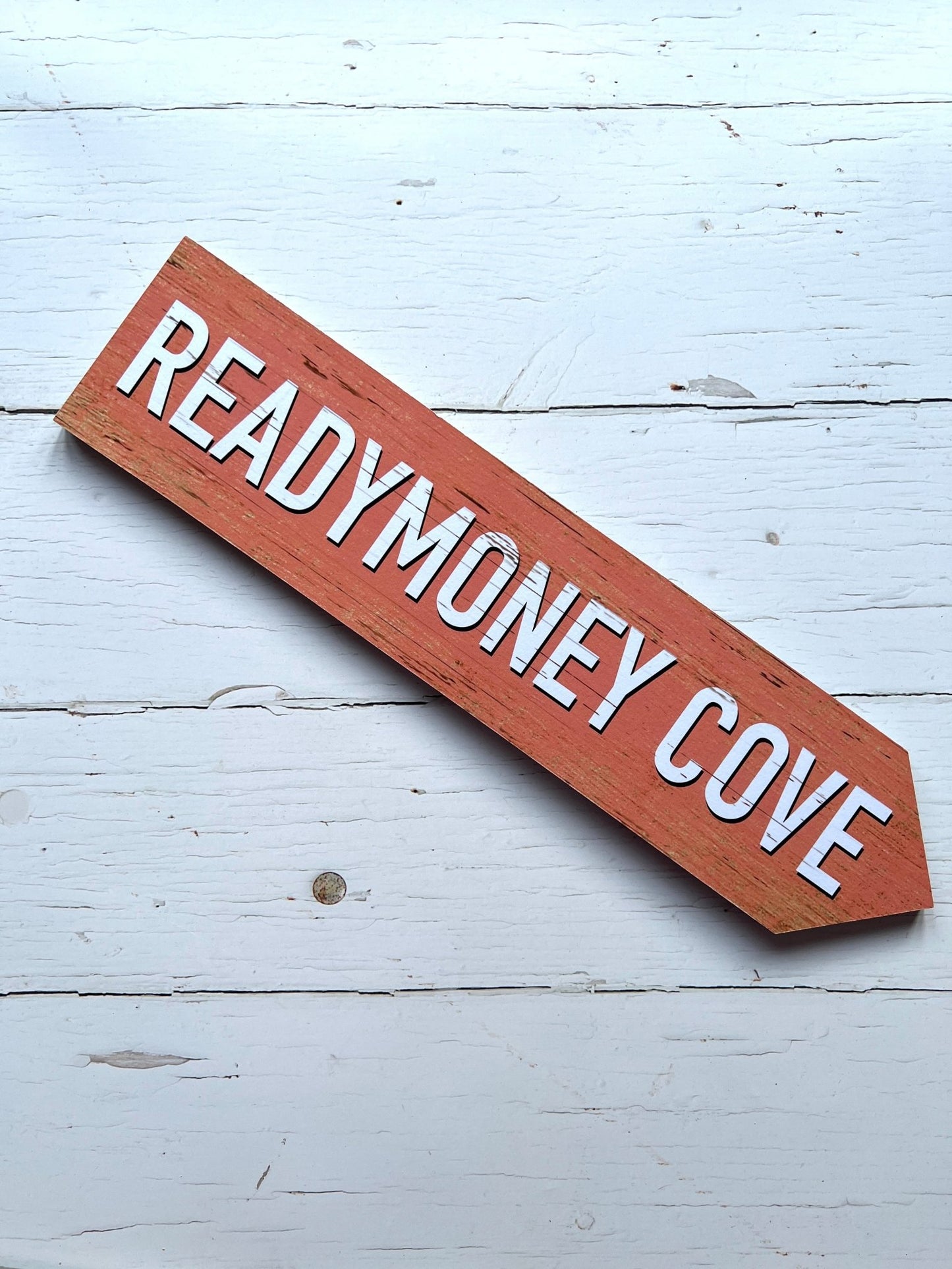 pink 'Readymoney Cove' single direction arrow sign coastal beach decor, vintage effect, wooden wall art, nautical theme