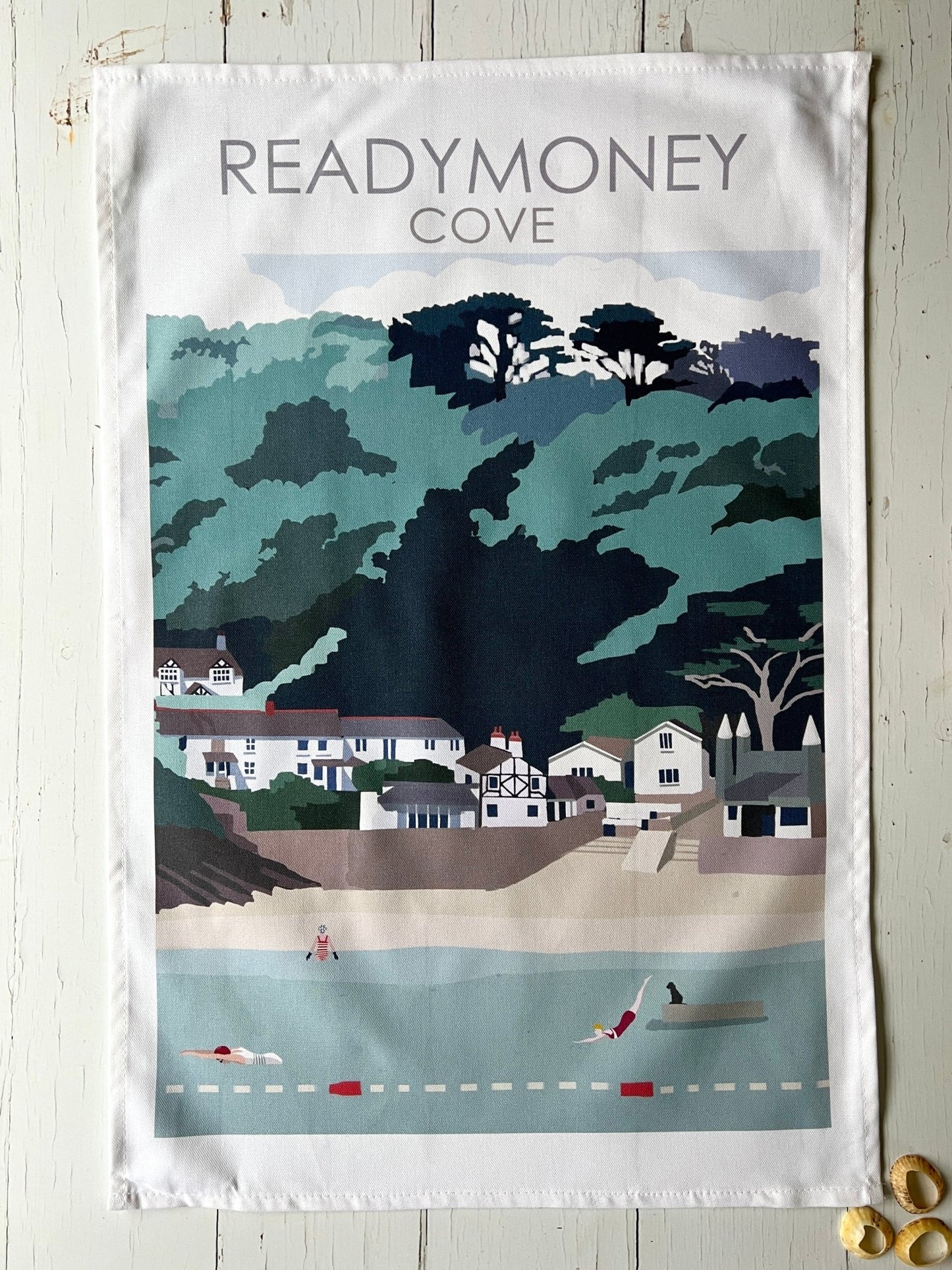 Readymoney Cove tea towel—playful coastal village illustration with swimmers, dog, and beach charm for seaside kitchen decor