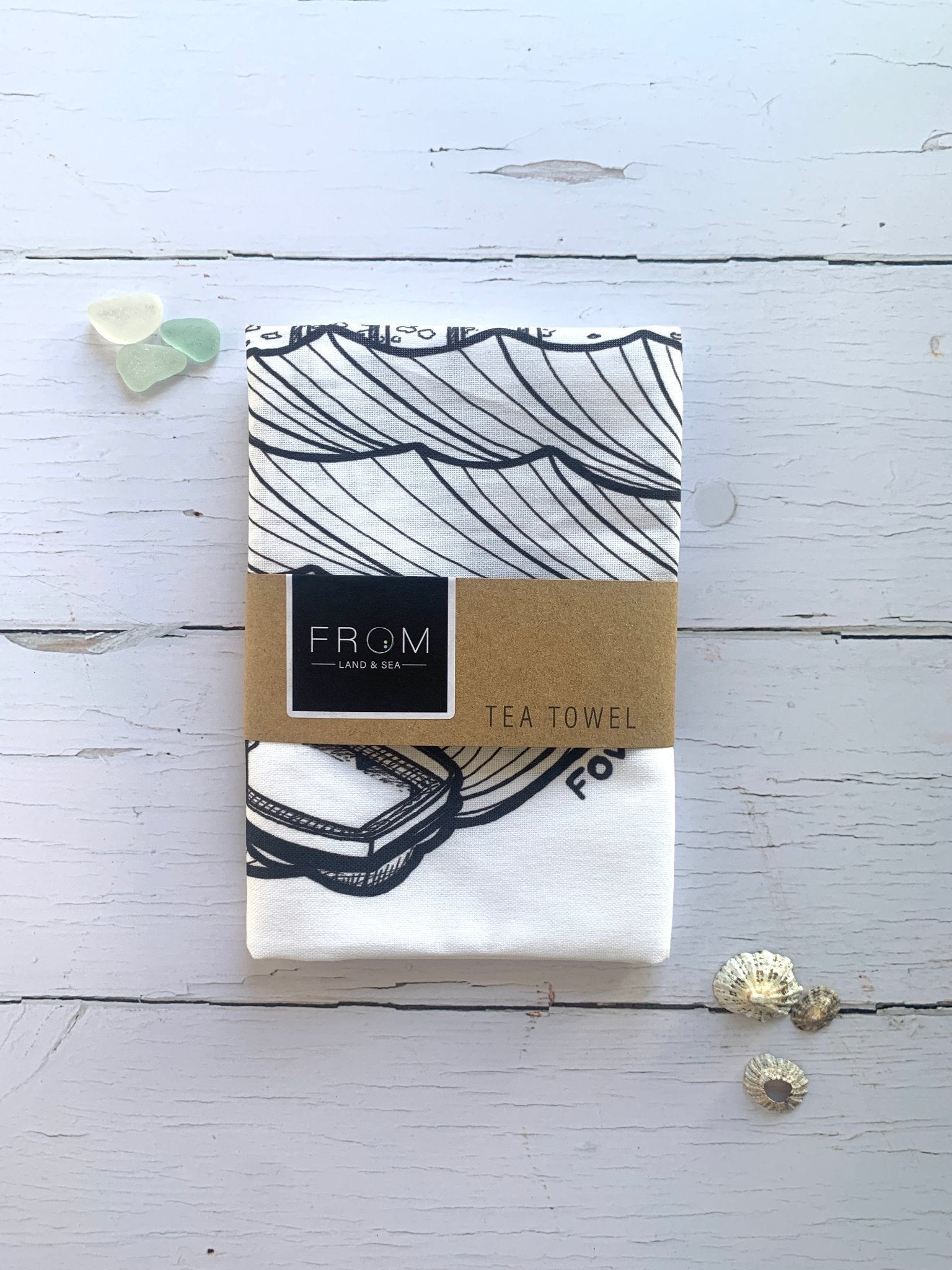 Fowey Town Quay tea towel—black and white coastal illustration with boats and waves, ideal for nautical kitchen decor