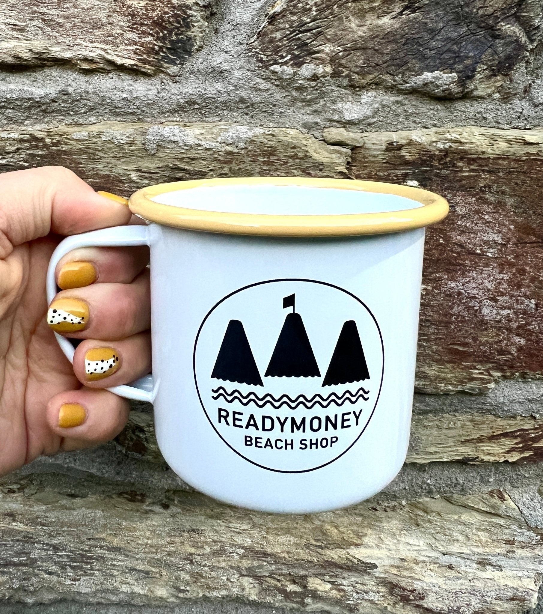 white enamel mug with yellow rim, featuring 'Readymoney Beach Shop' logo coastal, nautical, camping, durable metal cup