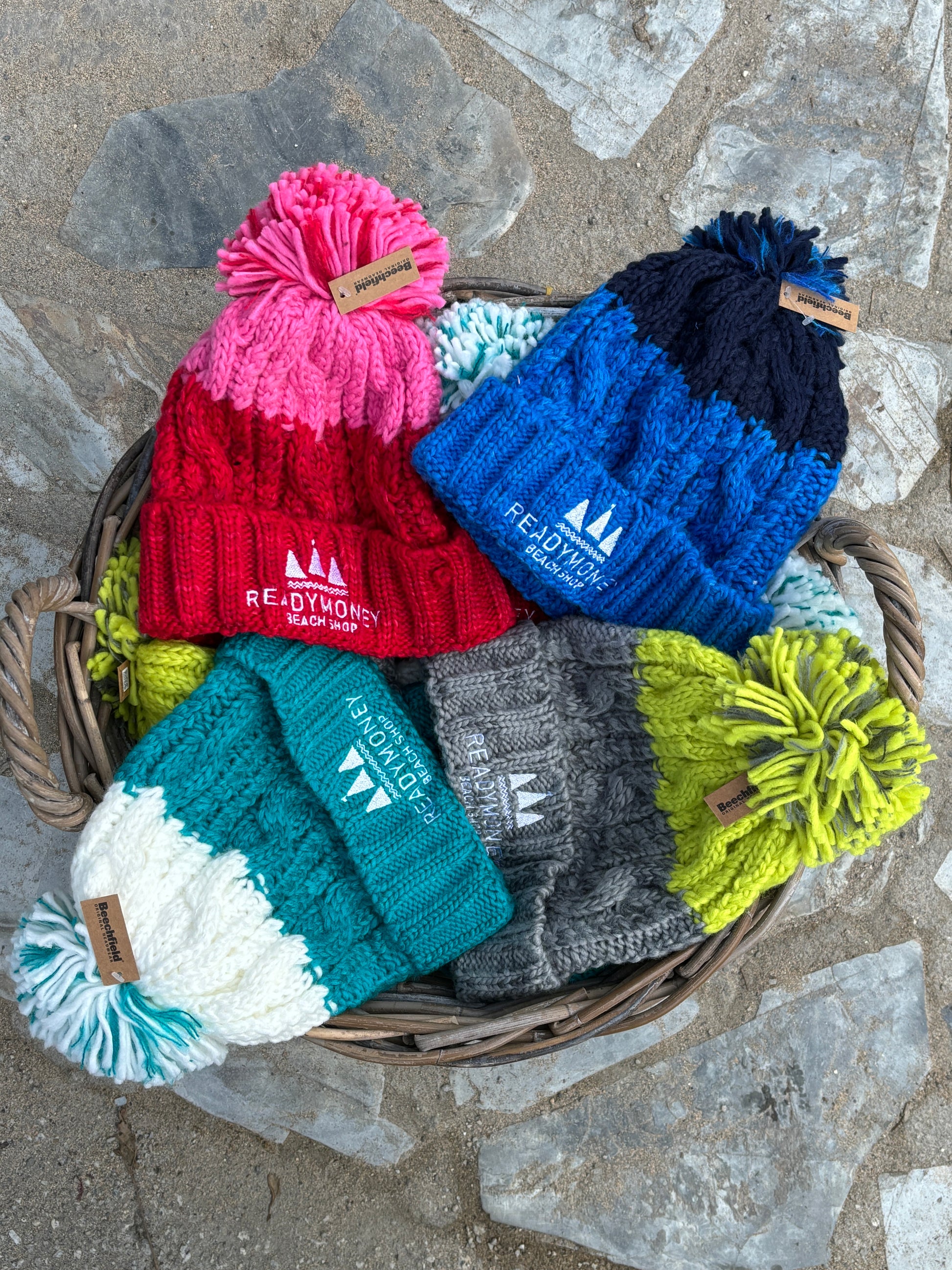 chunky two-toned kids’ bobble hat with faux fur pom-pom and beach shop logo—warm, playful, and winter-ready