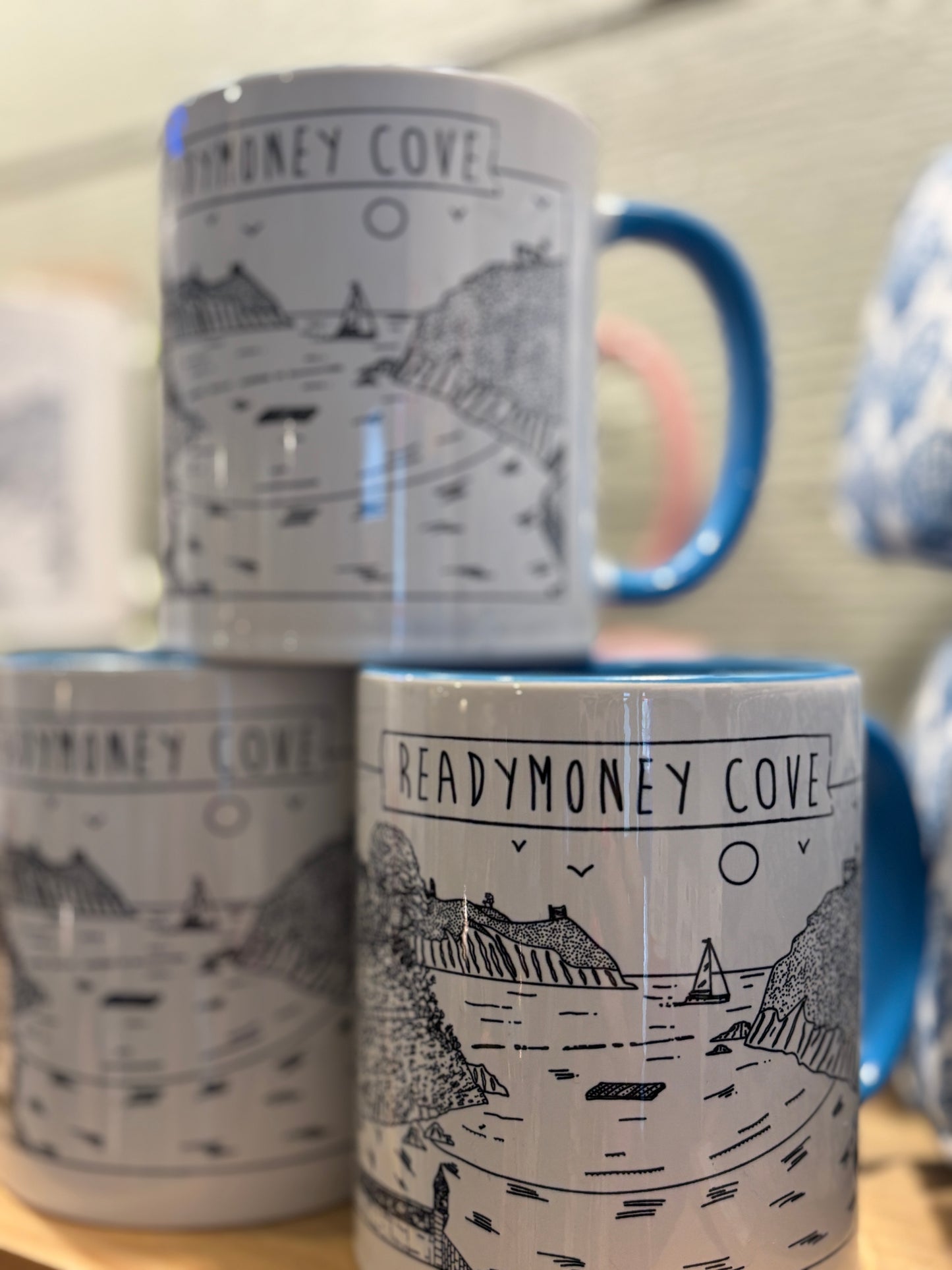 mug with black & white illustration of readymoney cove.Blue handle and interior
