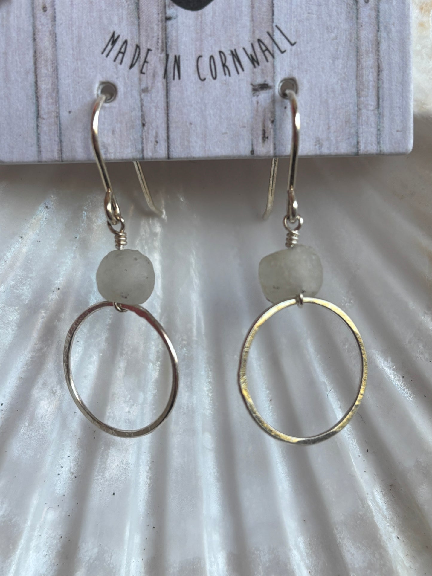 close-up of handmade sterling silver drop hoops with recycled pale grey glass beads ethical Cornwall jewelry gift, nautical look
